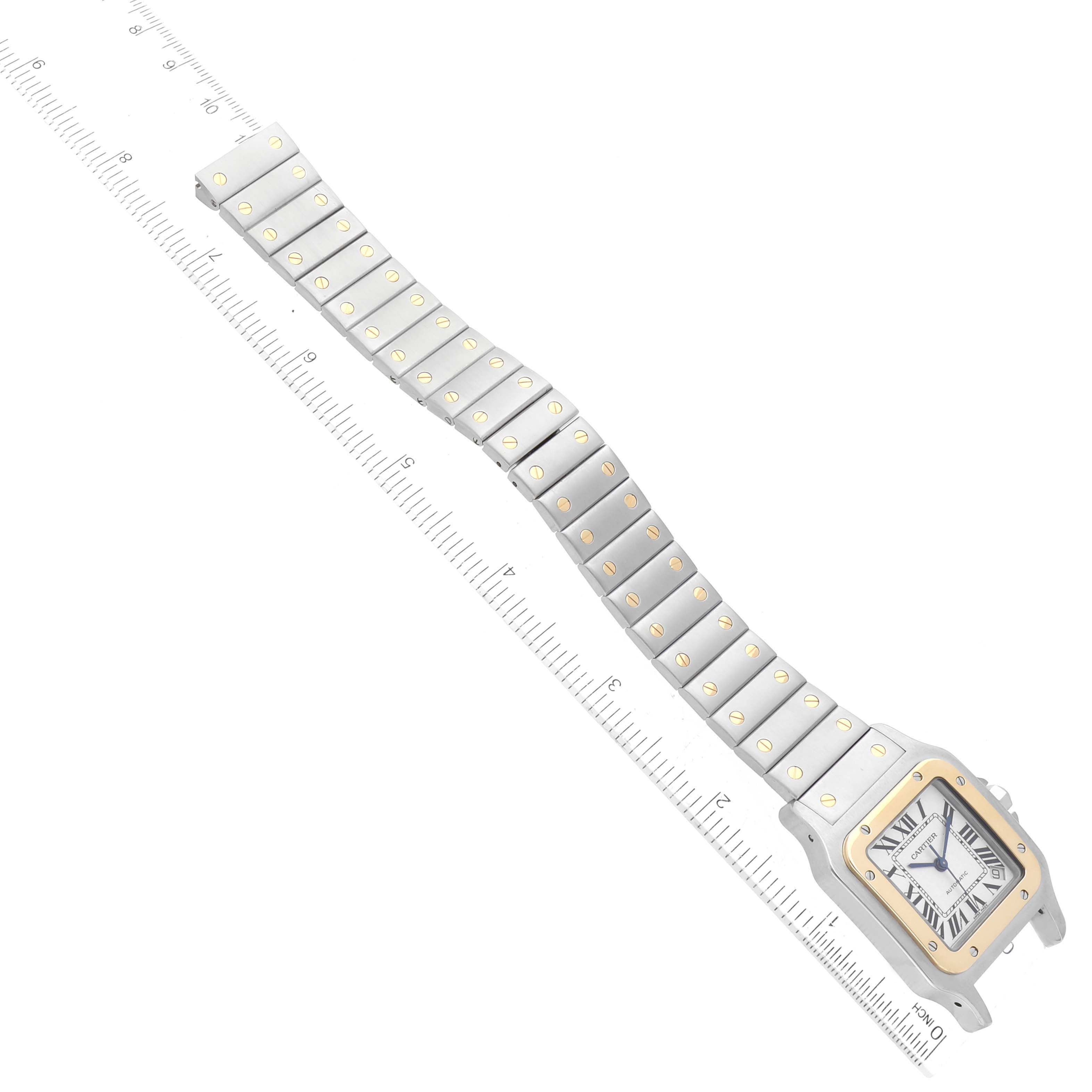 The Cartier Santos W20099C4 Men
s Steel and Gold (two tone) Silver Dial W20099C4 Men
s Steel and Gold (two tone) Silver Dial watch is displayed at a diagonal angle, showing the face, bezel, and full metal bracelet with ruler measurements.