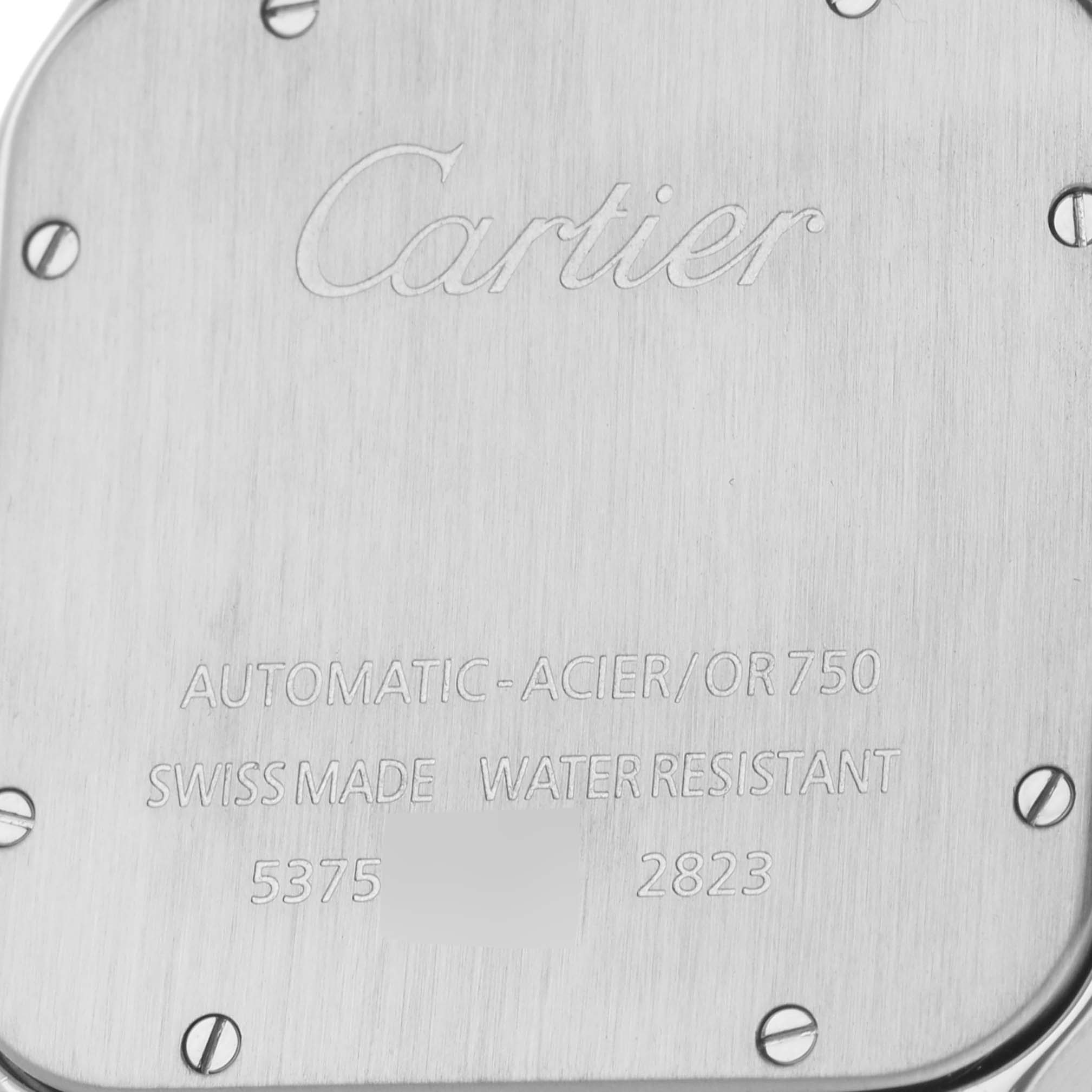 This image shows the back case of a Cartier Santos W20099C4 Men
s Steel and Gold (two tone) Silver Dial W20099C4 Men
s Steel and Gold (two tone) Silver Dial watch, featuring engraved text and screws.