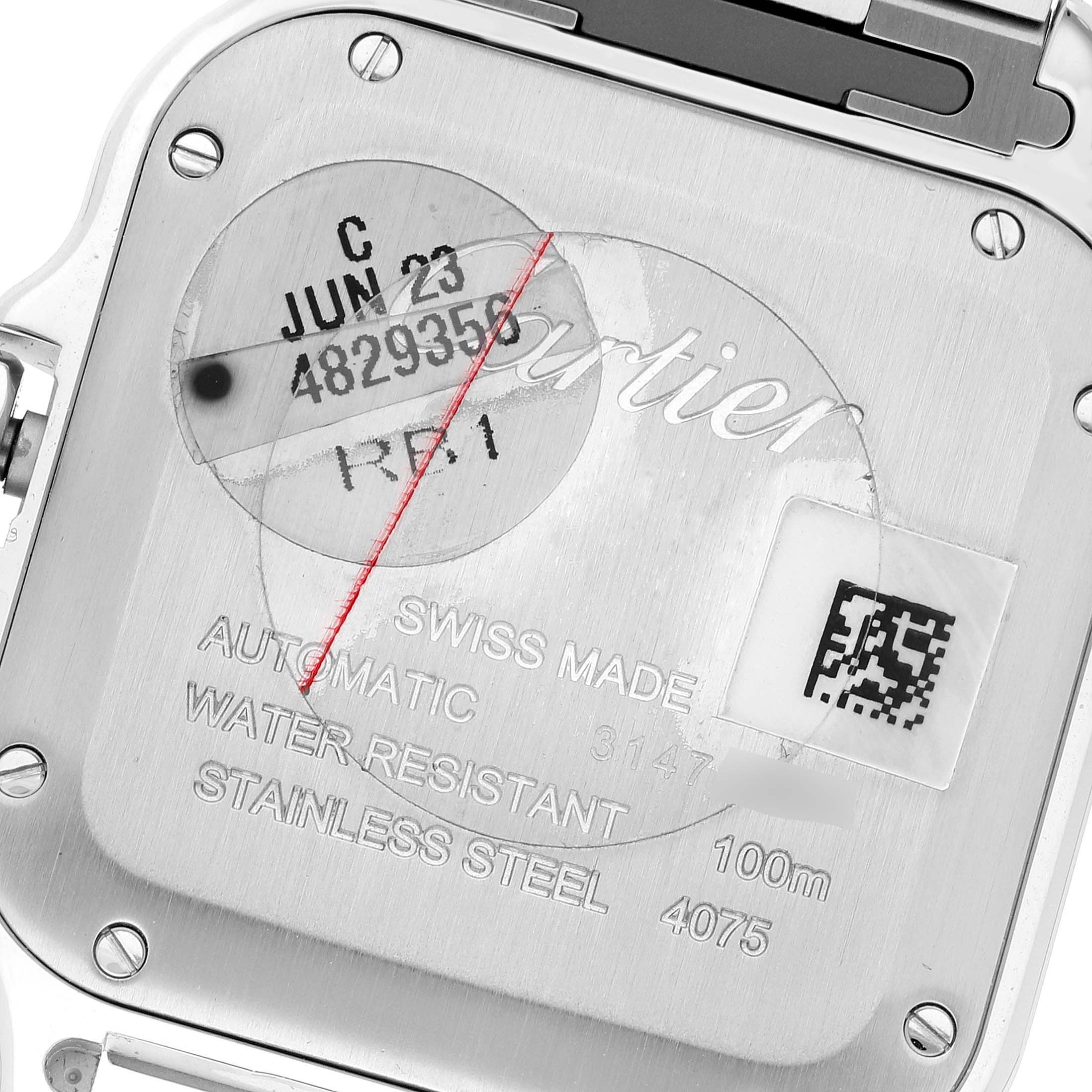 The image shows the back case of a Santos model by Cartier, displaying engraving details and specifications.