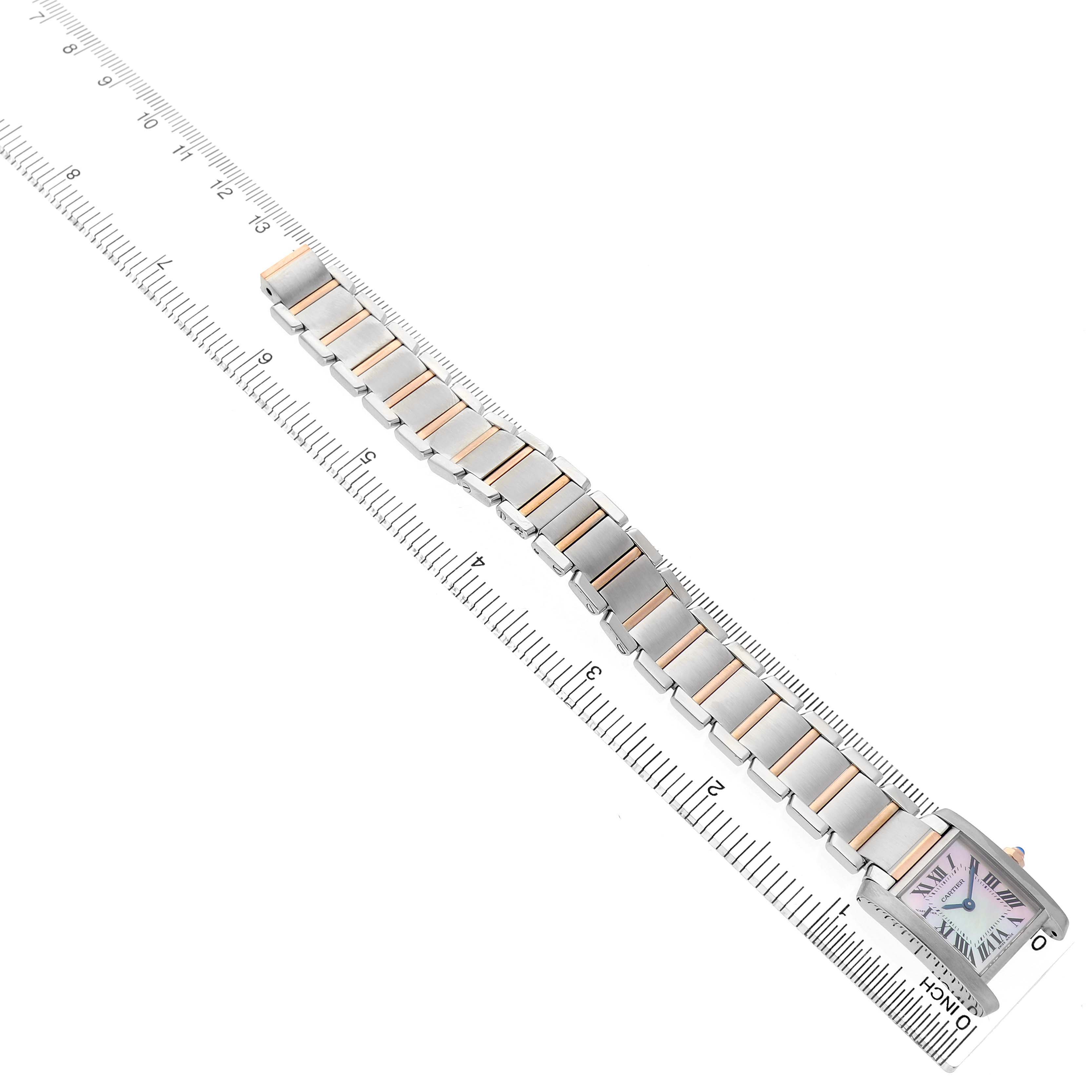 The Cartier Tank Française watch is shown from a top-down angle, displaying its face and the full length of the bracelet aligned on a ruler.