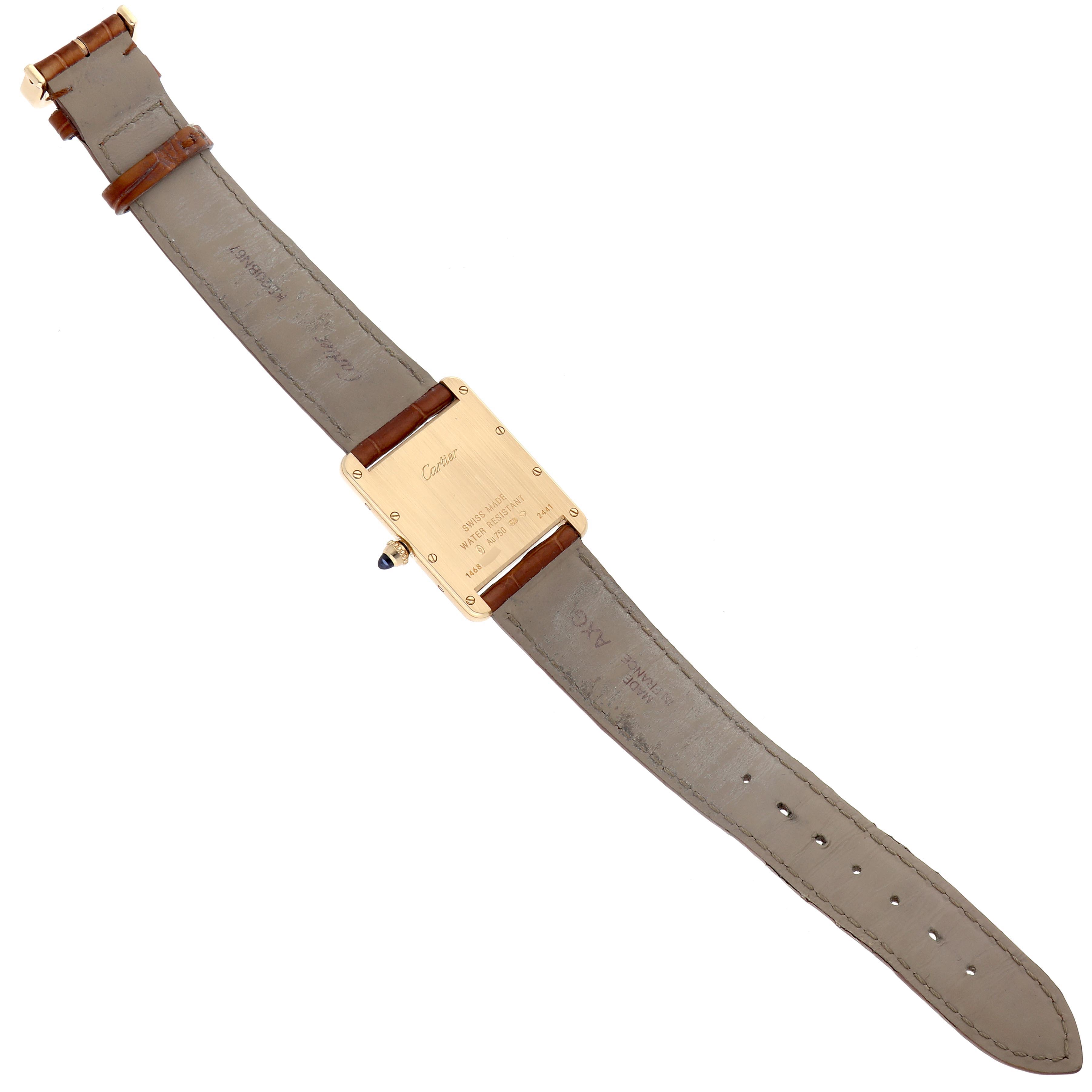 The Cartier Tank Louis W1529756 Men's Yellow Gold Silver Dial W1529756 Men's Yellow Gold Silver Dial watch is shown from the back, displaying its case, strap, and clasp.