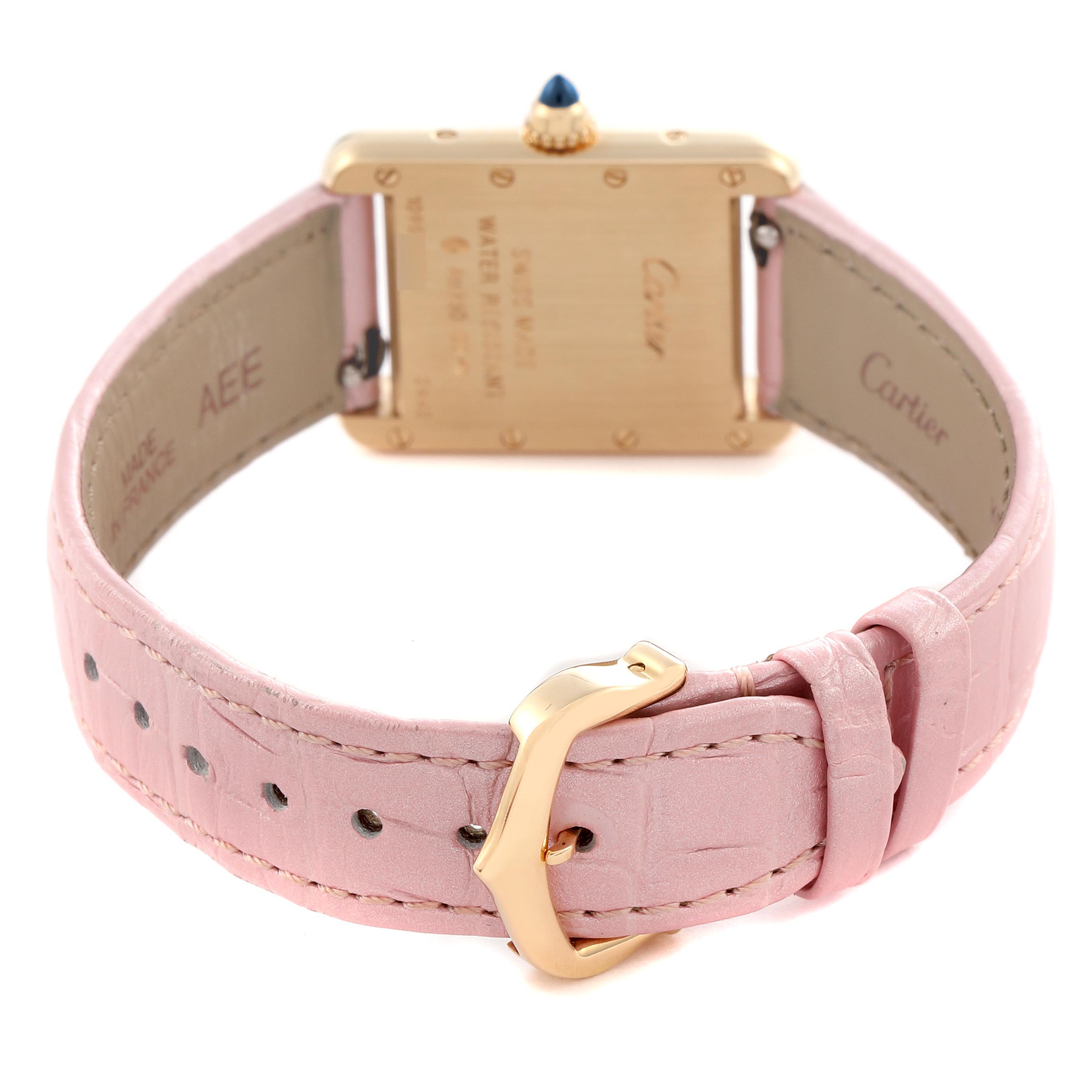 The Cartier Tank Louis W1529856 Women's Yellow Gold Silver Dial W1529856 Women's Yellow Gold Silver Dial watch is shown from the back, displaying its caseback, pink strap, and gold buckle.