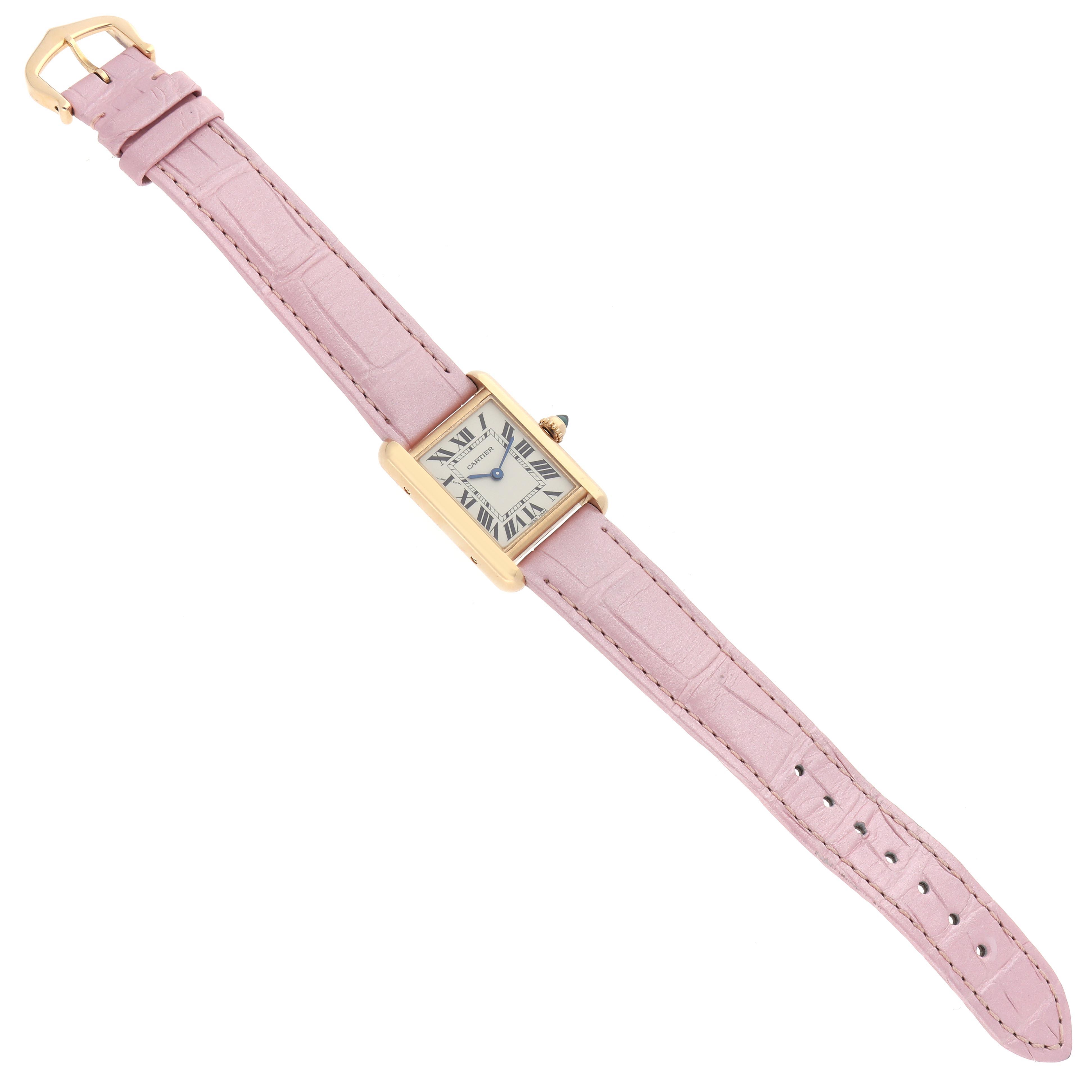 The Cartier Tank Louis W1529856 Women's Yellow Gold Silver Dial W1529856 Women's Yellow Gold Silver Dial watch is shown at a slight angle, highlighting its pink strap, rectangular case, and crown detail.