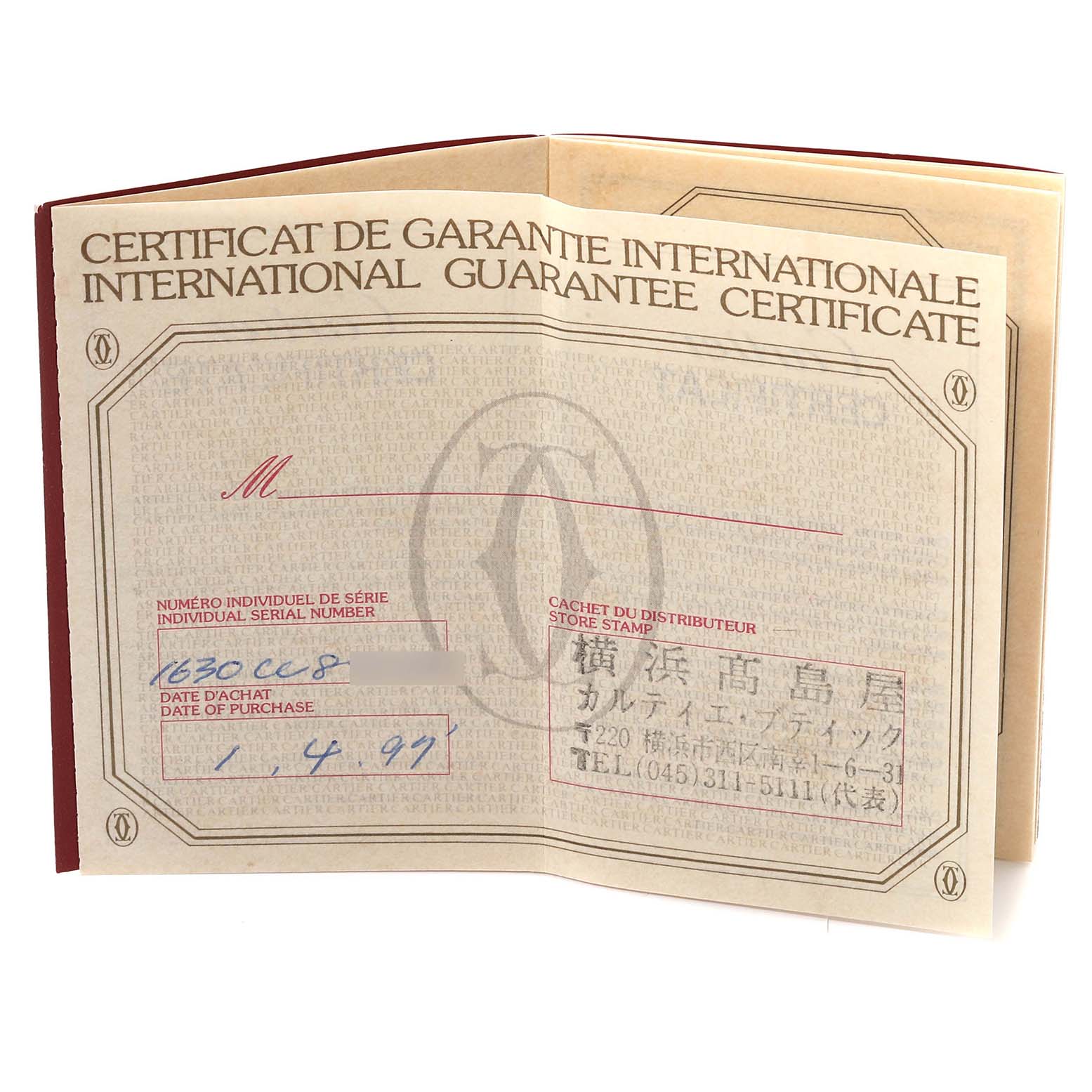 This image shows the open international guarantee certificate for the Cartier Tank Obus WB800351 Women's Yellow Gold Silver Dial WB800351 Women's Yellow Gold Silver Dial watch.