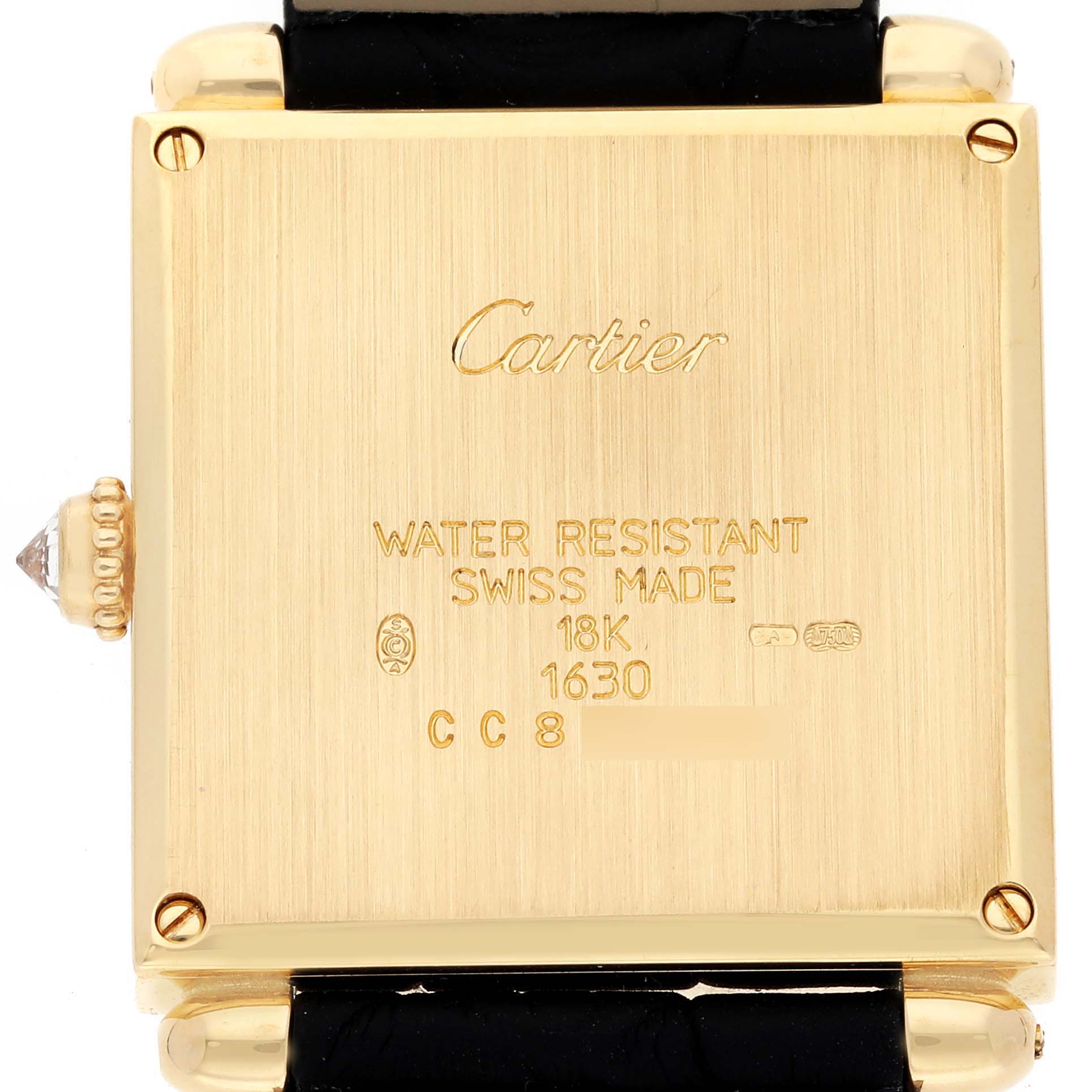 This image shows the back of a Cartier Tank Obus WB800351 Women's Yellow Gold Silver Dial WB800351 Women's Yellow Gold Silver Dial watch, displaying its inscriptions and part of the strap.
