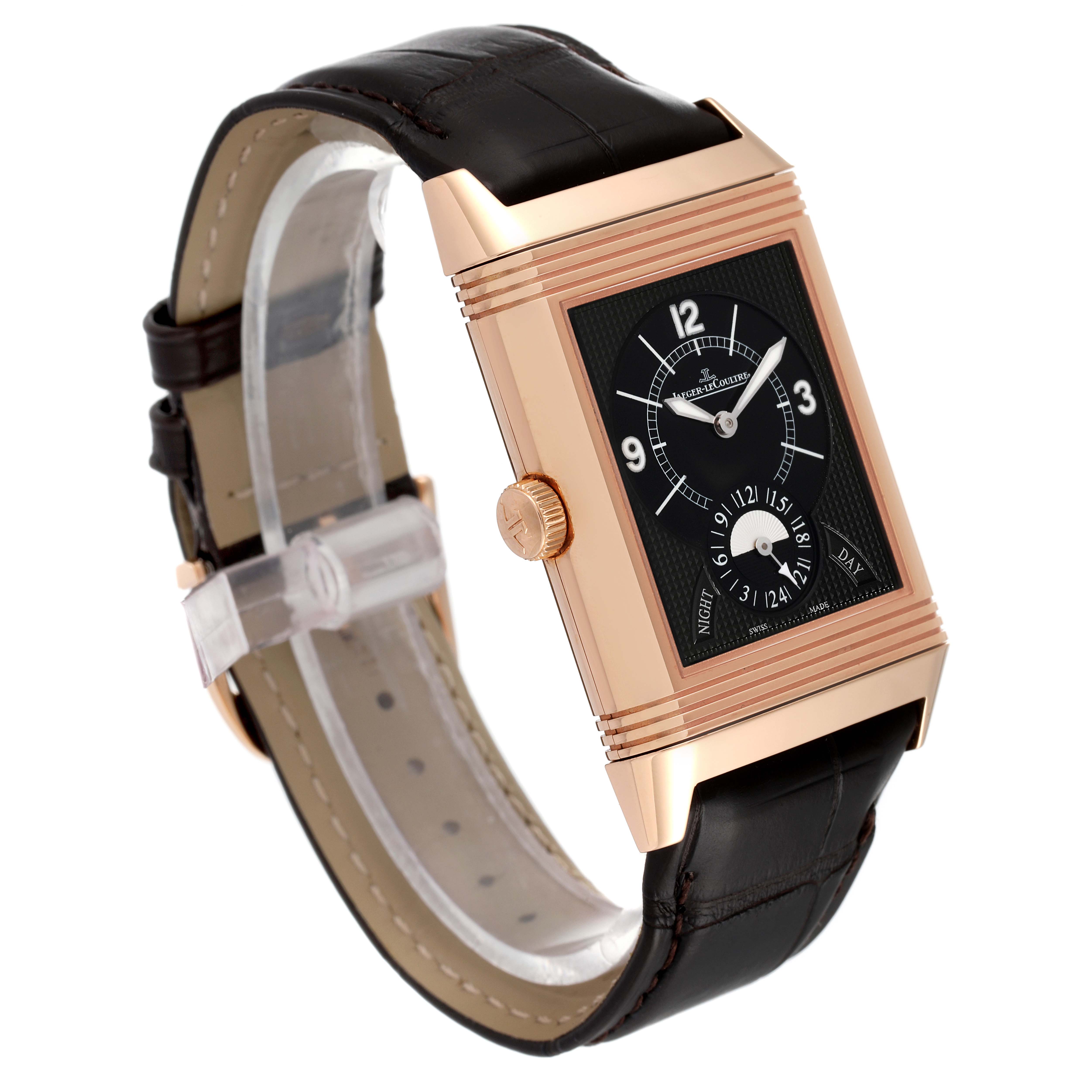 The image shows a Jaeger-LeCoultre Reverso watch from a three-quarter angle, highlighting its rectangular face, rose gold case, and black leather strap.