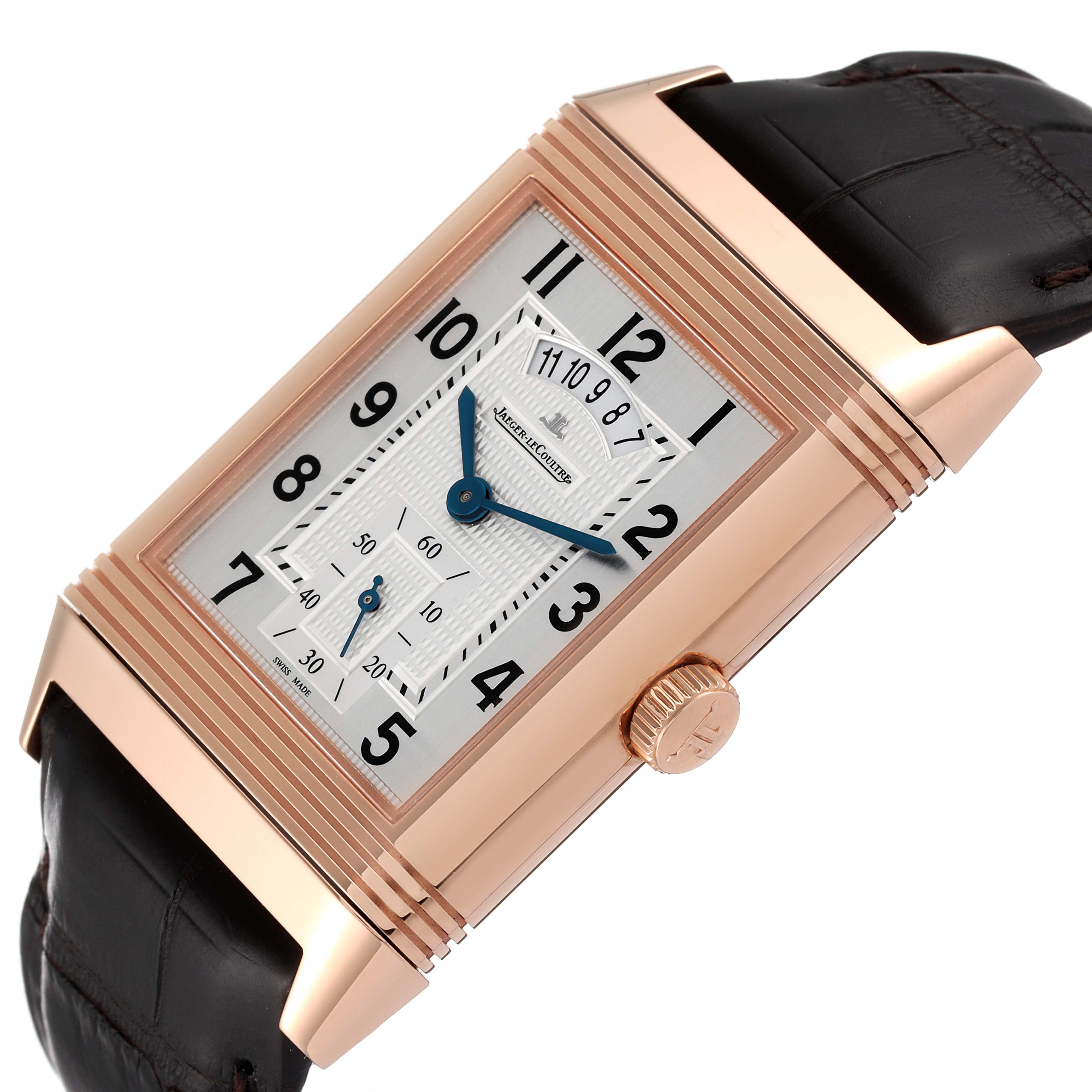 The Jaeger LeCoultre Reverso Q3742521 Men
s Rose Gold Silver Dial Q3742521 Men
s Rose Gold Silver Dial watch is shown at a tilted angle, highlighting its rectangular face, crown, and leather strap.
