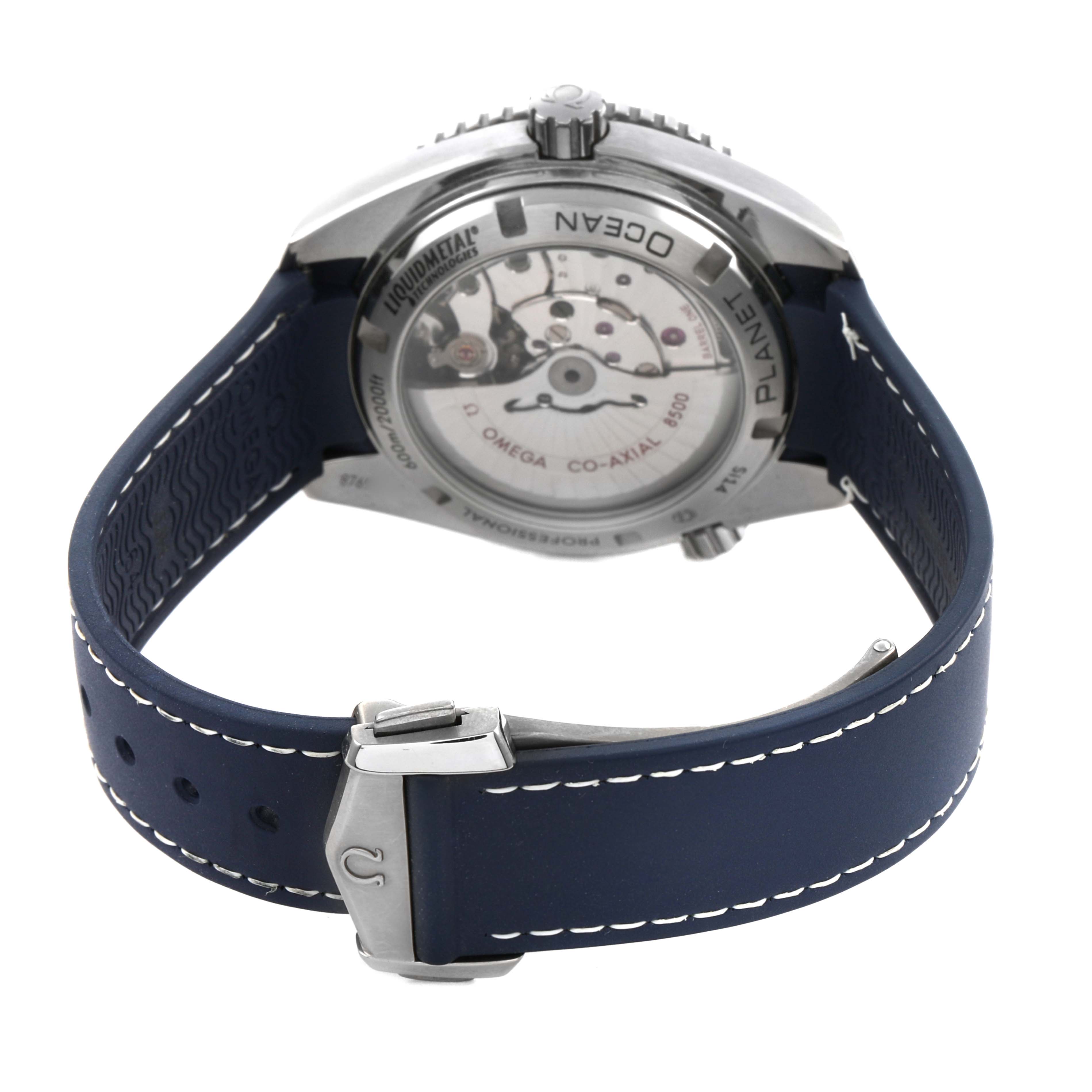 The image shows the back view of the Omega Planet Ocean 232.92.42.21.03.001 Men's Stainless Steel Blue Dial, highlighting the transparent case back and blue strap with clasp.