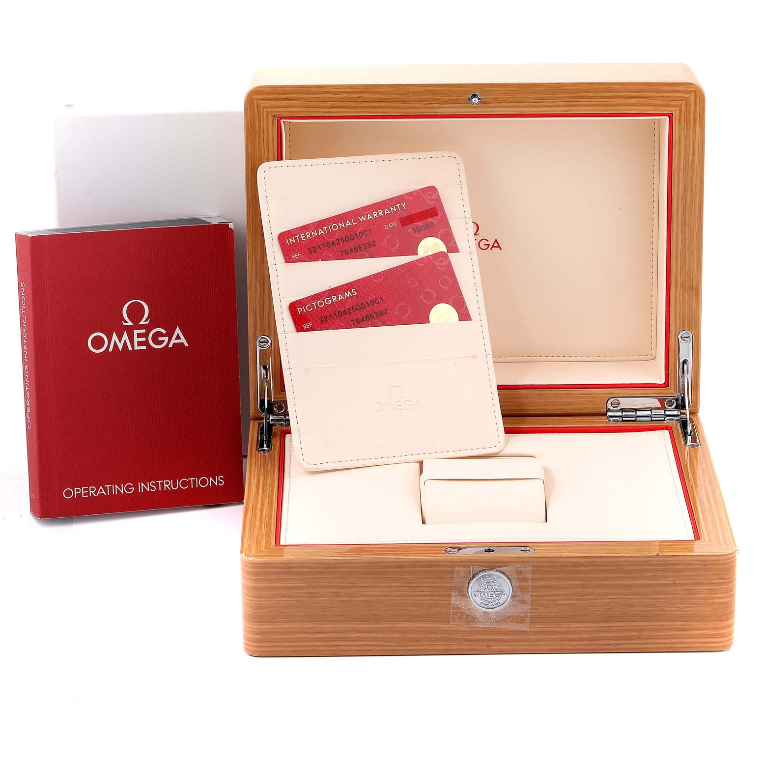 The image shows the Omega Speedmaster 321.10.42.50.01.001 Men
s Stainless Steel Black Dial 321.10.42.50.01.001 Men
s Stainless Steel Black Dial watch box, warranty cards, and operating instructions, seen from the front.