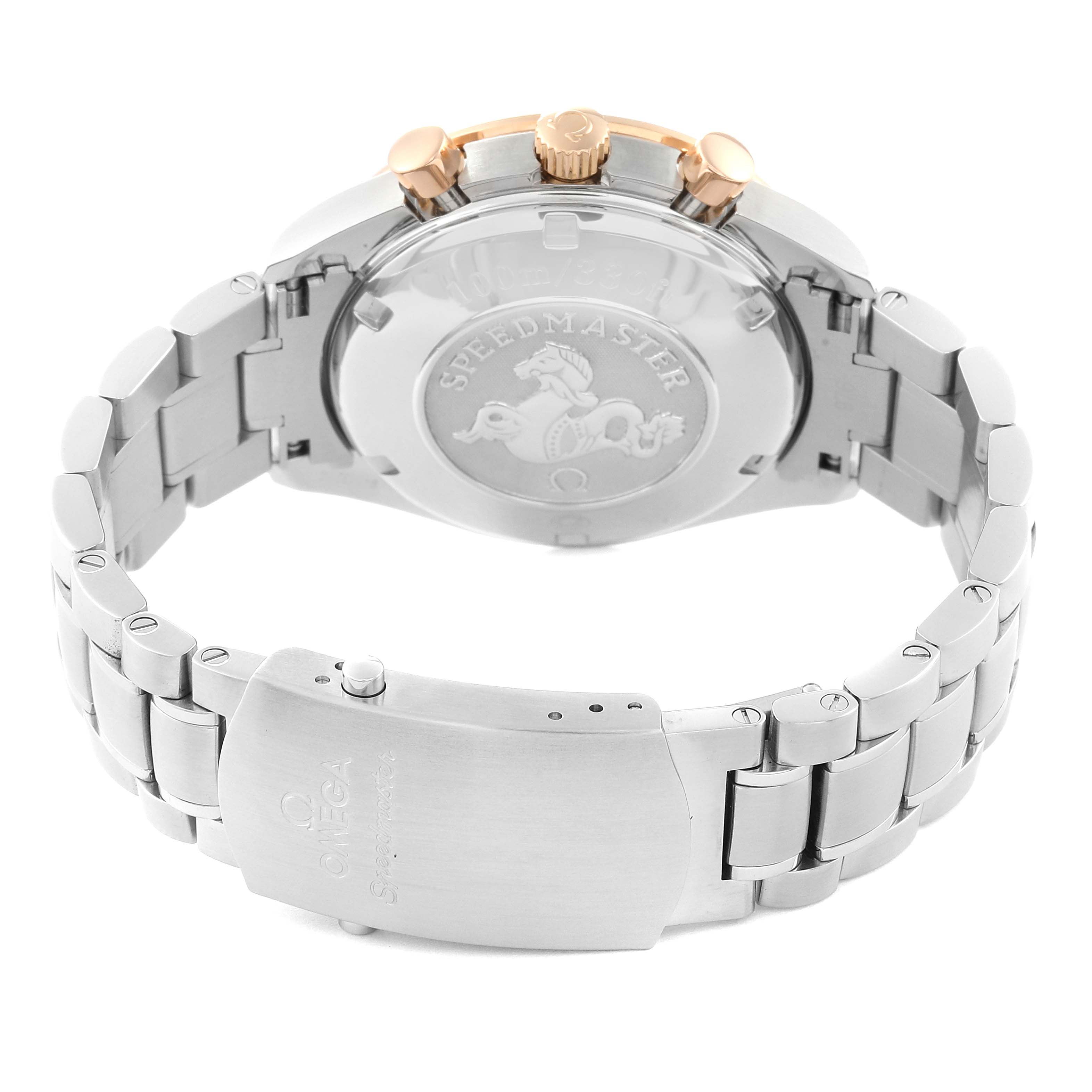 The image shows the back case, crown, and bracelet clasp of an Omega Speedmaster 323.21.40.44.01.001 Men's Steel and Gold (two tone) Black Dial 323.21.40.44.01.001 Men's Steel and Gold (two tone) Black Dial watch from a rear angle.