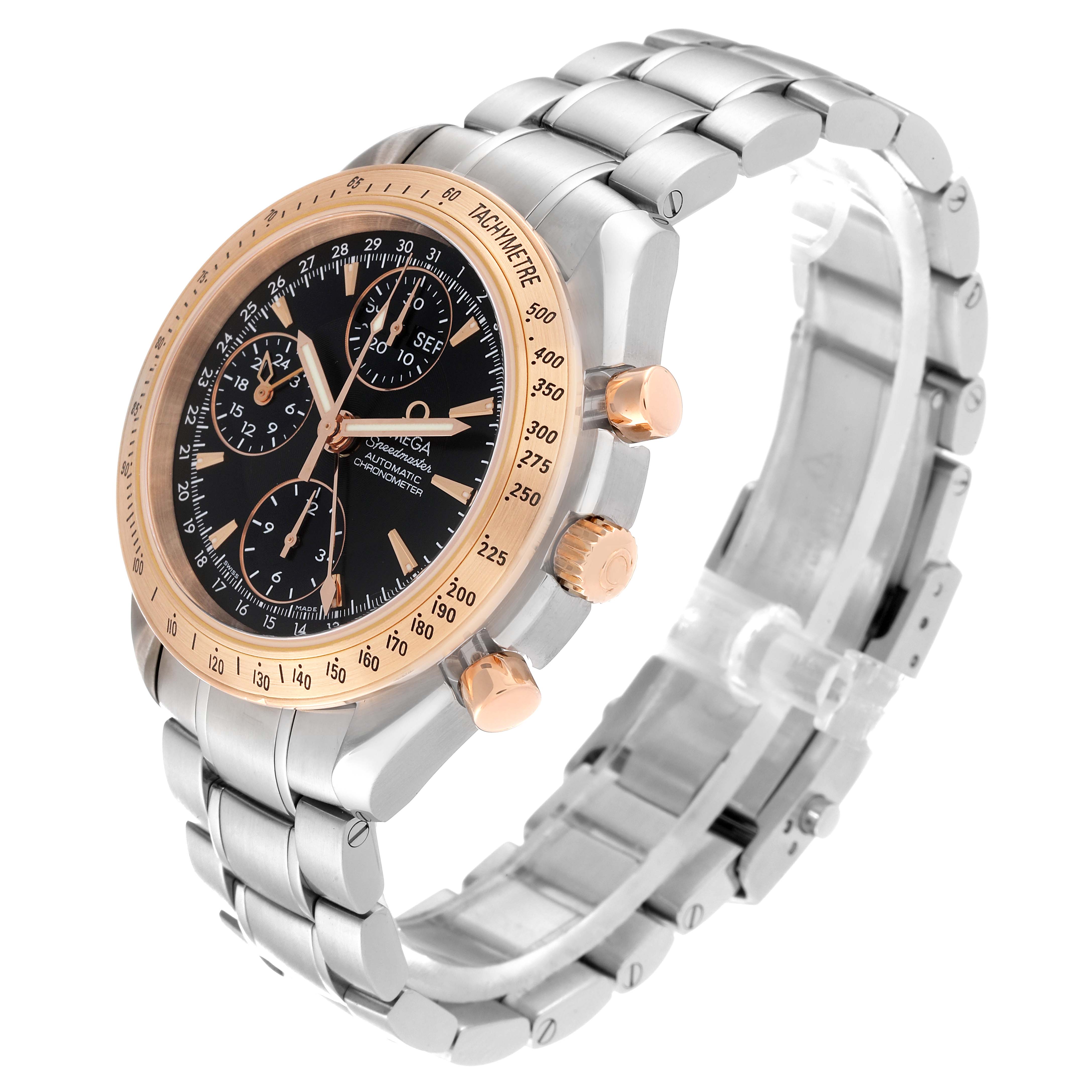 The image shows an Omega Speedmaster 323.21.40.44.01.001 Men's Steel and Gold (two tone) Black Dial 323.21.40.44.01.001 Men's Steel and Gold (two tone) Black Dial watch at a three-quarter angle highlighting the dial, bezel, chronograph buttons, and metal bracelet.