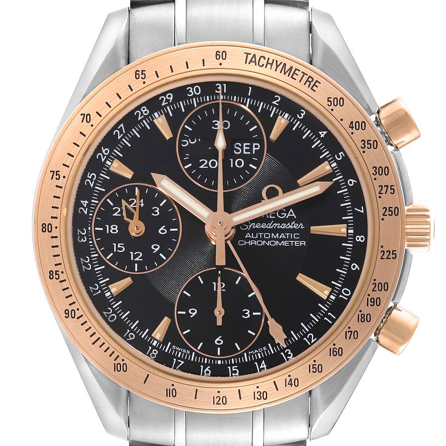 The Omega Speedmaster watch is shown from a front angle displaying the dial, bezel, and pushers.