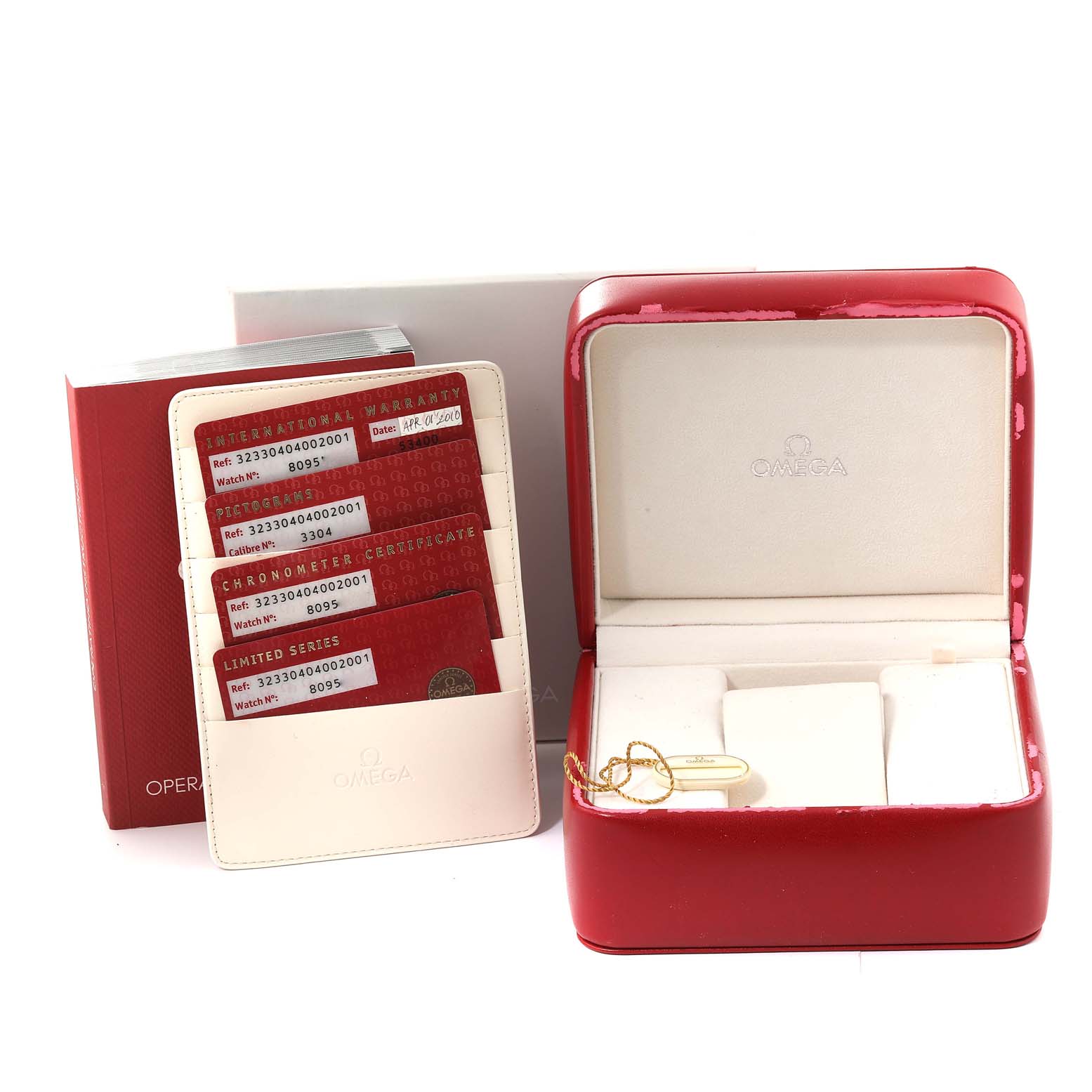 The image displays the Omega Speedmaster 323.30.40.40.02.001 Men
s Stainless Steel White Dial 323.30.40.40.02.001 Men
s Stainless Steel White Dial watch
s red case, warranty cards, and operating instructions from a frontal angle.