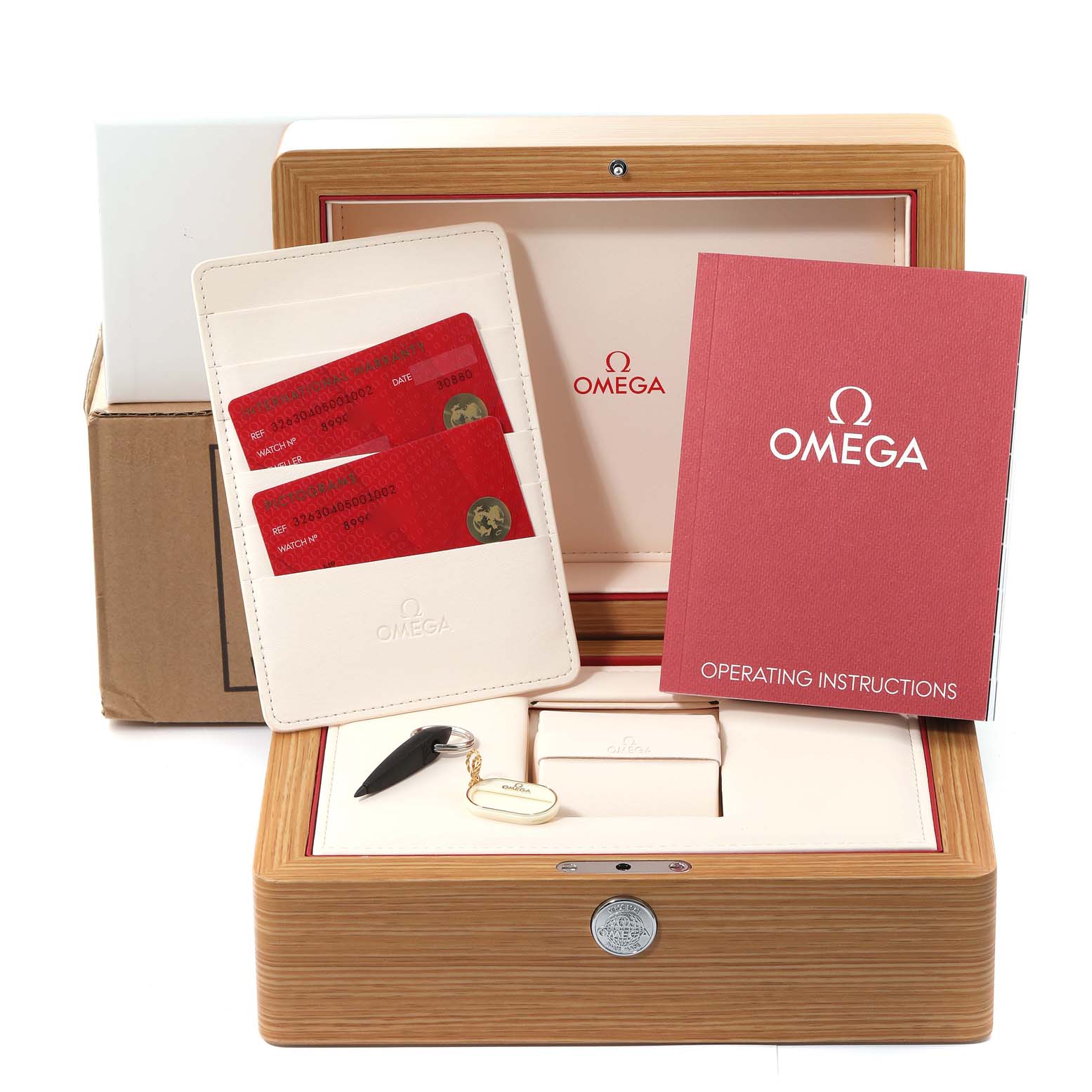 The image shows an Omega Speedmaster 326.30.40.50.01.002 Men
s Stainless Steel Black Dial 326.30.40.50.01.002 Men
s Stainless Steel Black Dial watch box, warranty cards, operating instructions, and a key.