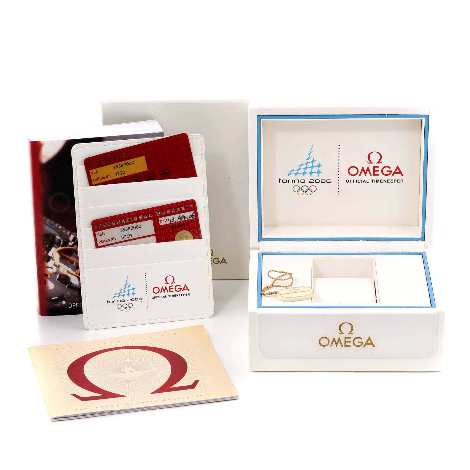 The image shows the Omega Speedmaster 3538.30.00 Men's Stainless Steel White Dial 3538.30.00 Men's Stainless Steel White Dial's packaging, including warranty cards, manuals, and a watch box from a front angle.