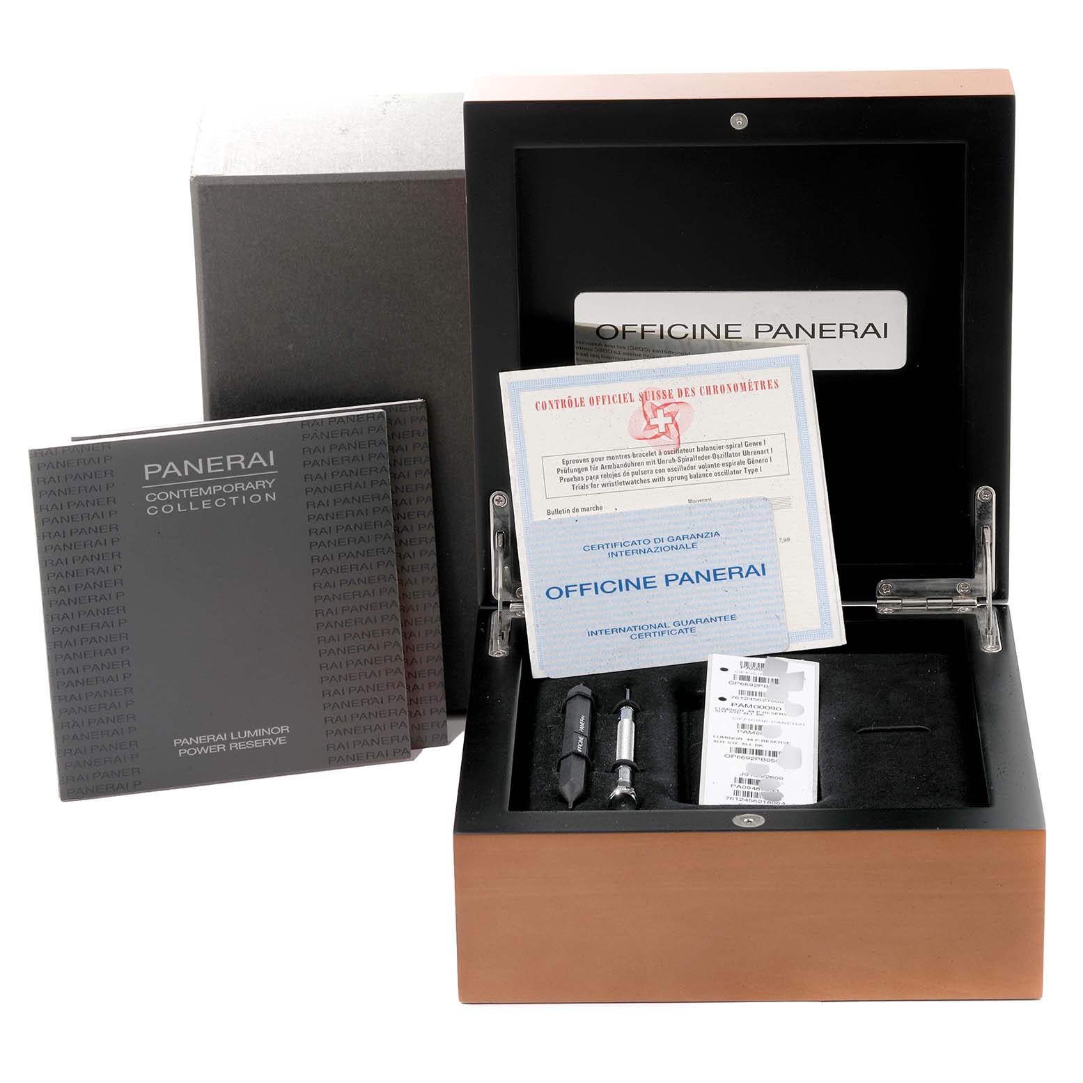 This image shows the packaging and accessories for a Panerai Luminor PAM00090 Men
s Stainless Steel Black Dial PAM00090 Men
s Stainless Steel Black Dial watch, including a storage box, manuals, certificates, and tools.