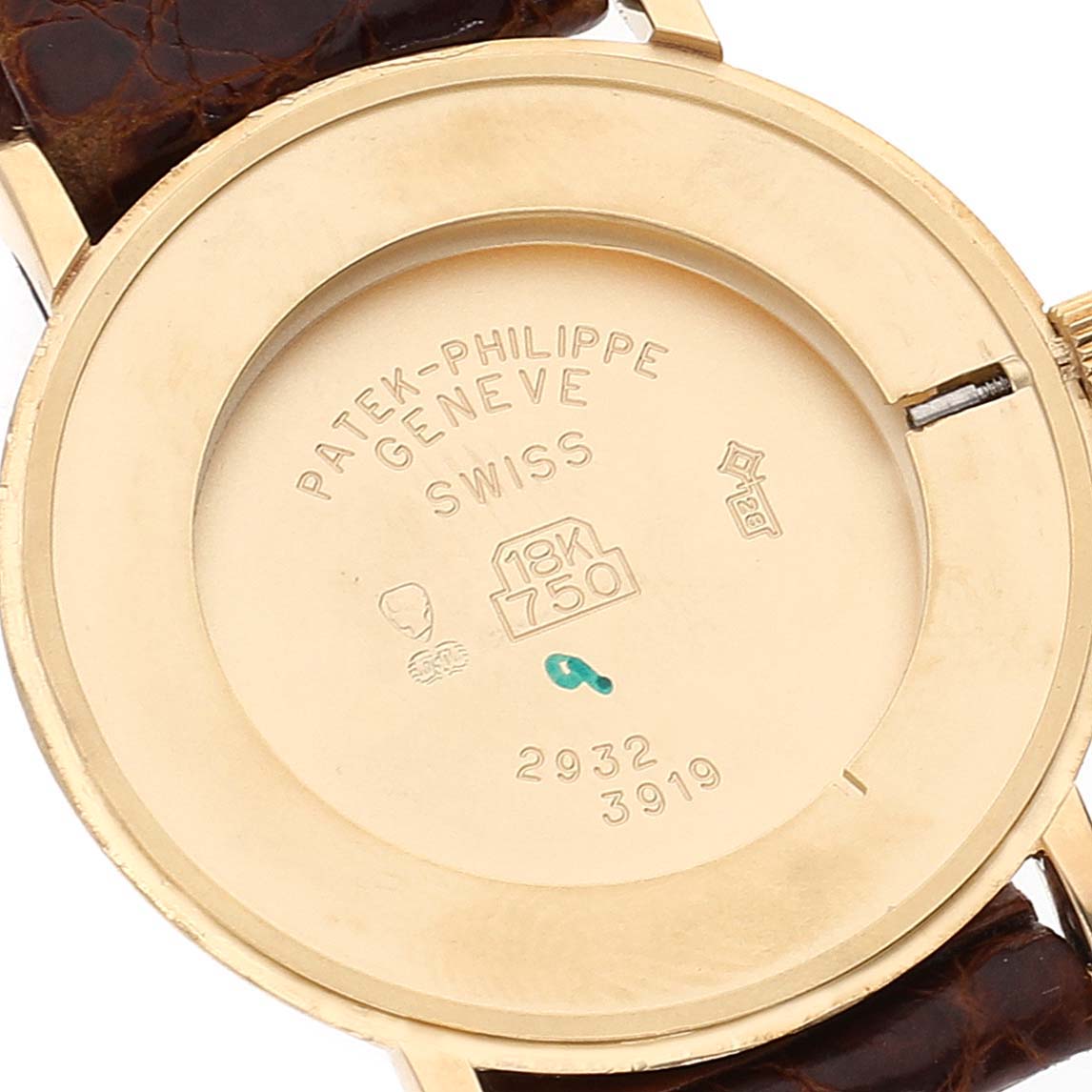 The image shows the back of a Patek Philippe Calatrava 3919J Men's Yellow Gold White Dial 3919J Men's Yellow Gold White Dial watch case with engraved markings.