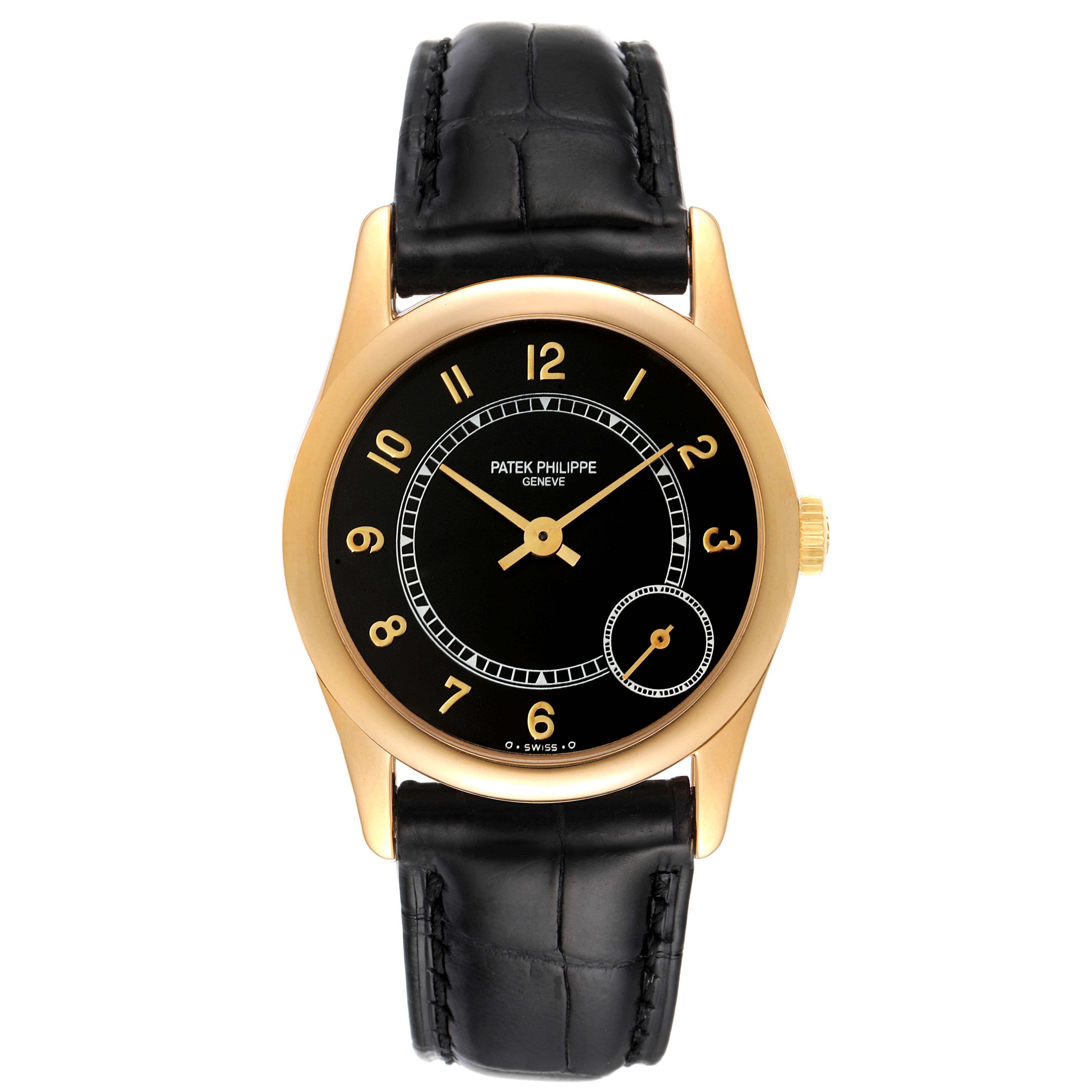 The Calatrava model by Patek Philippe is shown from a front angle, displaying its black dial, gold case, and black leather strap.