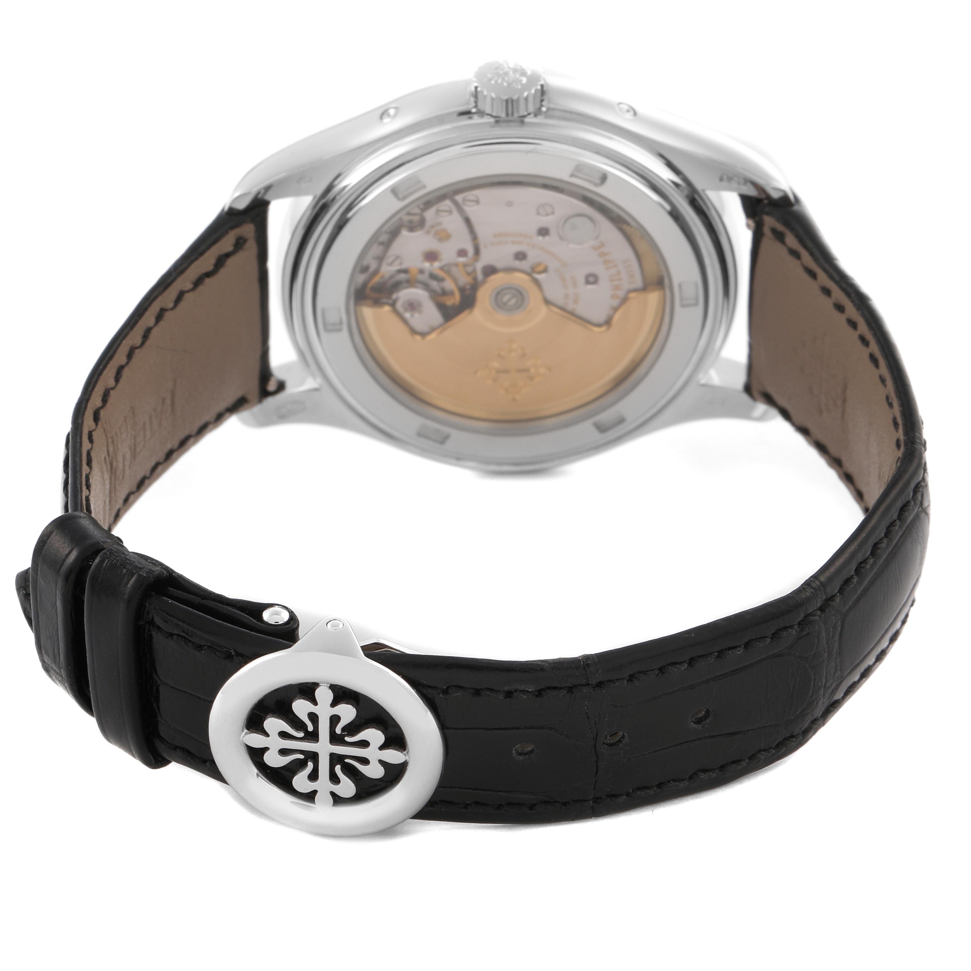 The Patek Philippe Complications 5146G-010 Men's White Gold Grey Dial 5146G-010 Men's White Gold Grey Dial watch is shown from the back, displaying the movement and leather strap with a branded clasp.