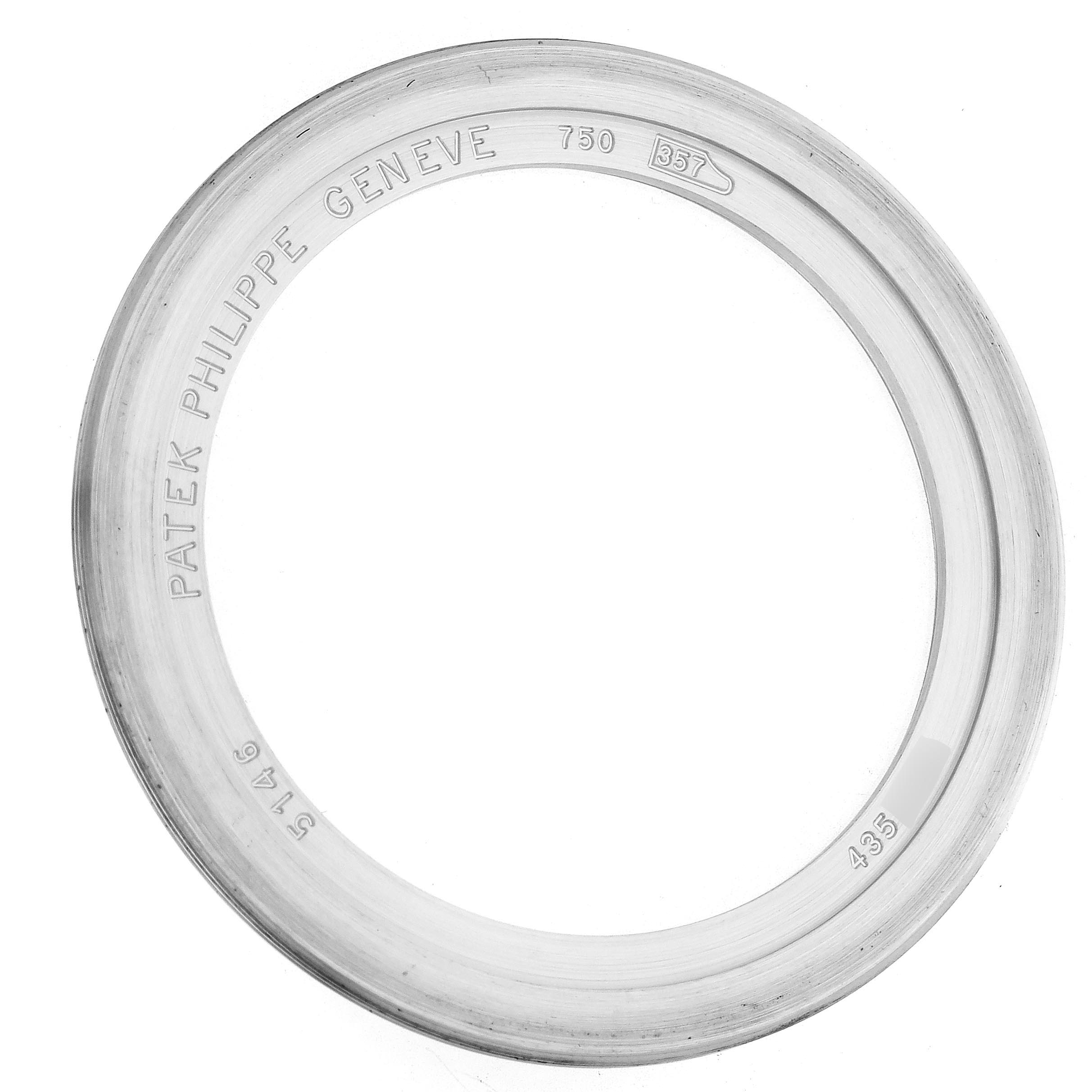 The image shows a top view of a bezel for a Patek Philippe Complications 5146G-010 Men's White Gold Grey Dial 5146G-010 Men's White Gold Grey Dial model, engraved with branding and reference numbers.