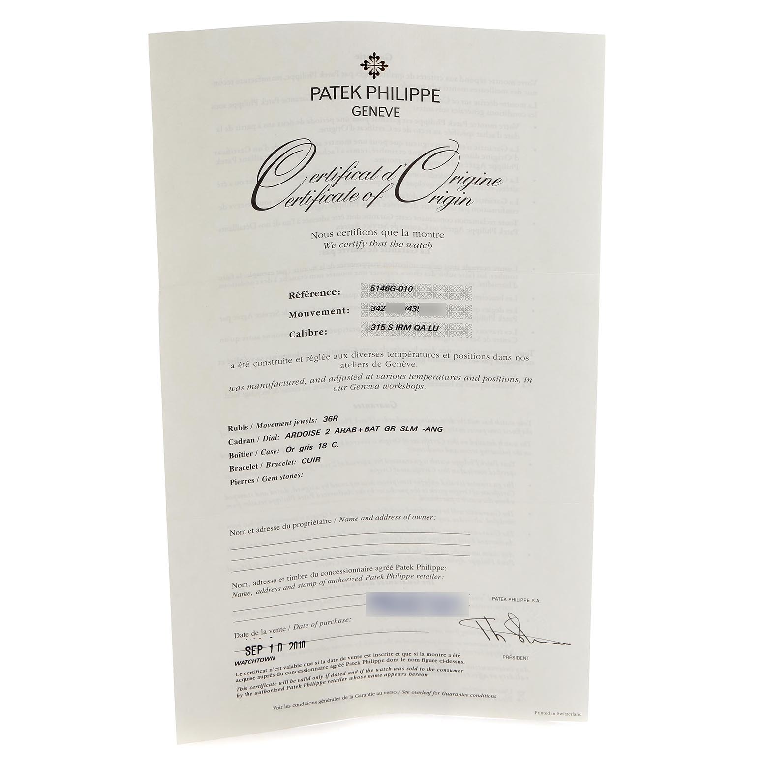 The image shows the Certificate of Origin for a Patek Philippe Complications 5146G-010 Men's White Gold Grey Dial 5146G-010 Men's White Gold Grey Dial model, viewed from a slightly angled perspective.