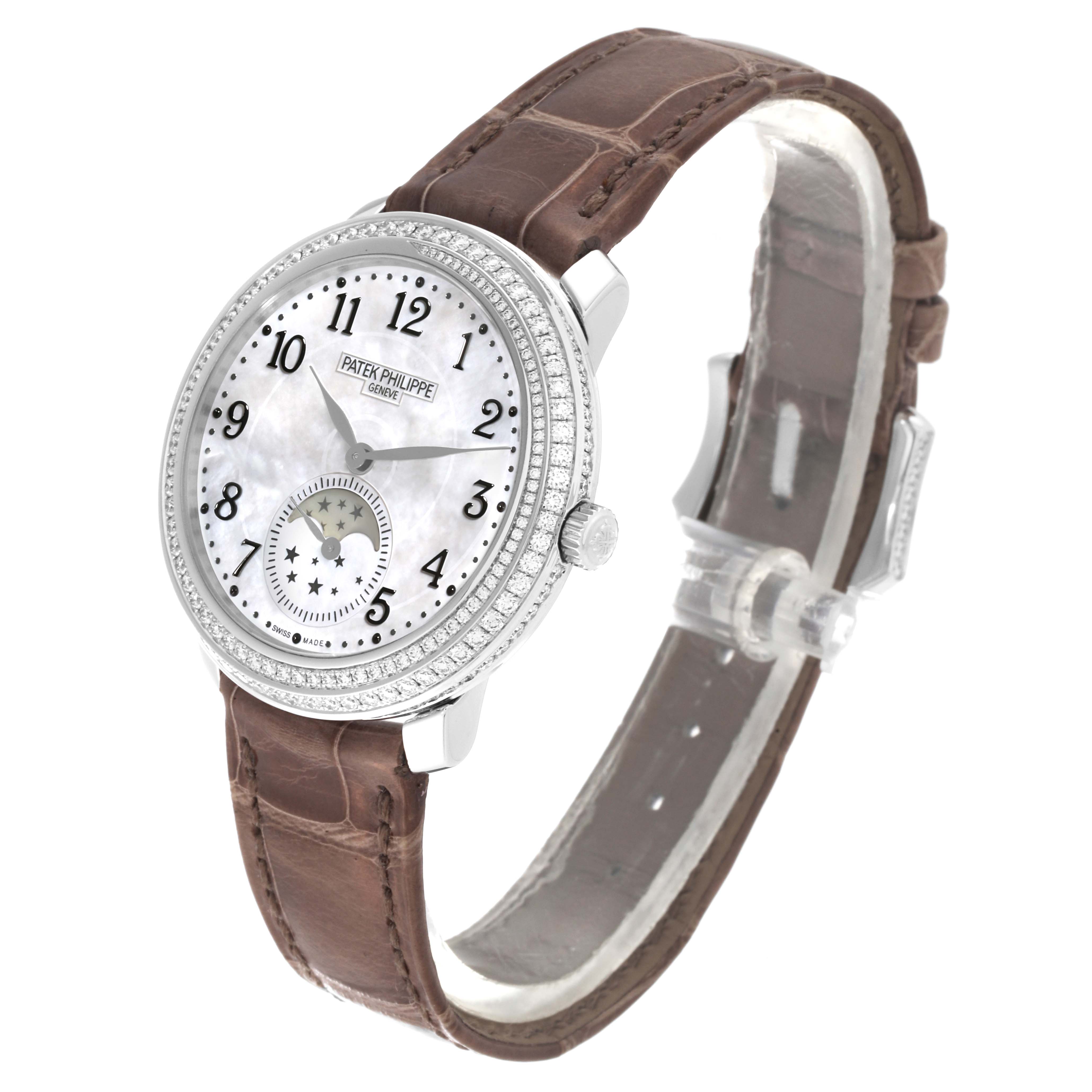 The Patek Philippe Complications 4968G-010 Women's White Gold Mother of Pearl Dial 4968G-010 Women's White Gold Mother of Pearl Dial watch is shown at a slight angle, highlighting the face, bezel, and brown leather strap.
