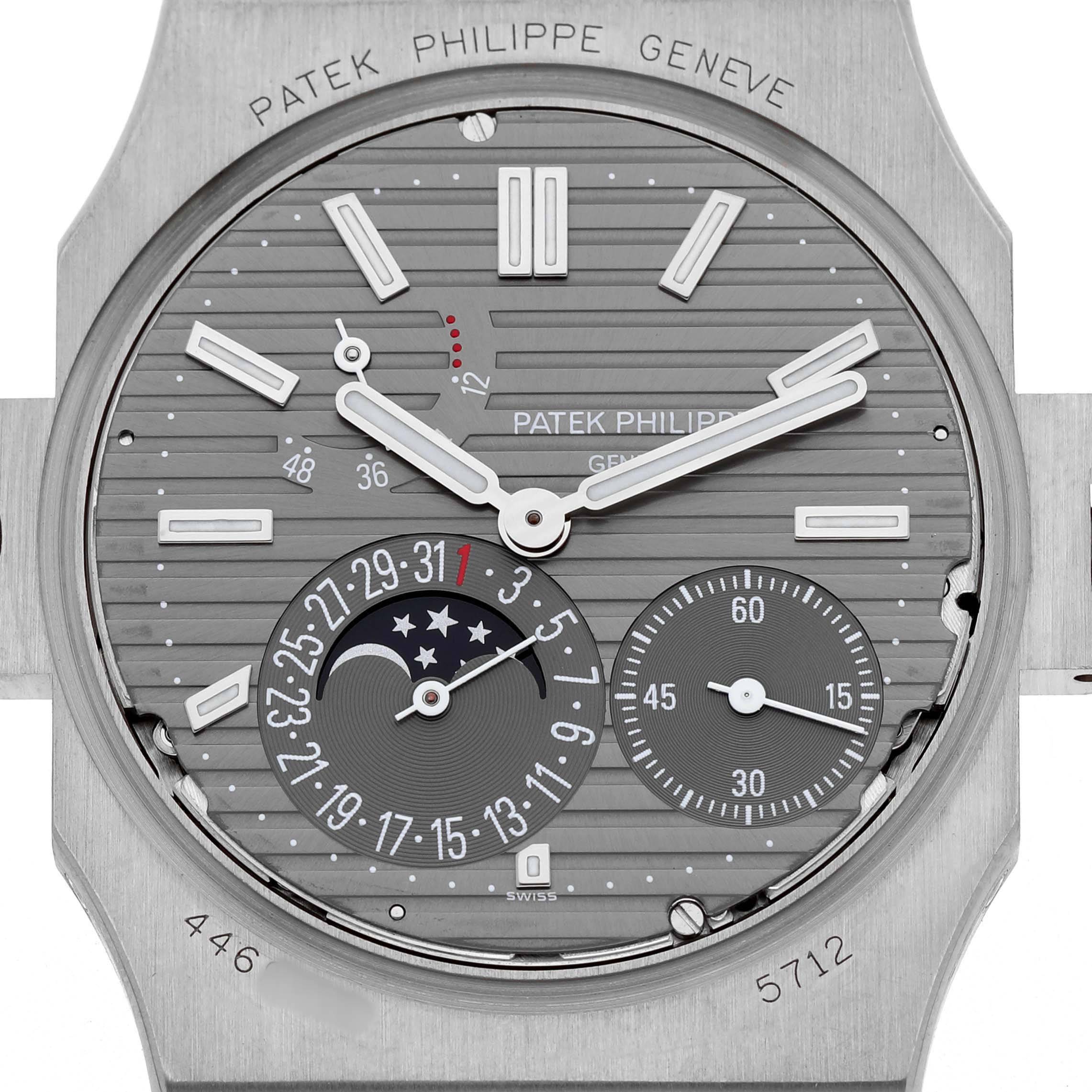 The image shows a close-up of the Patek Philippe Nautilus 5712G-001 Men's White Gold Grey Dial dial, highlighting the lunar and date subdials.