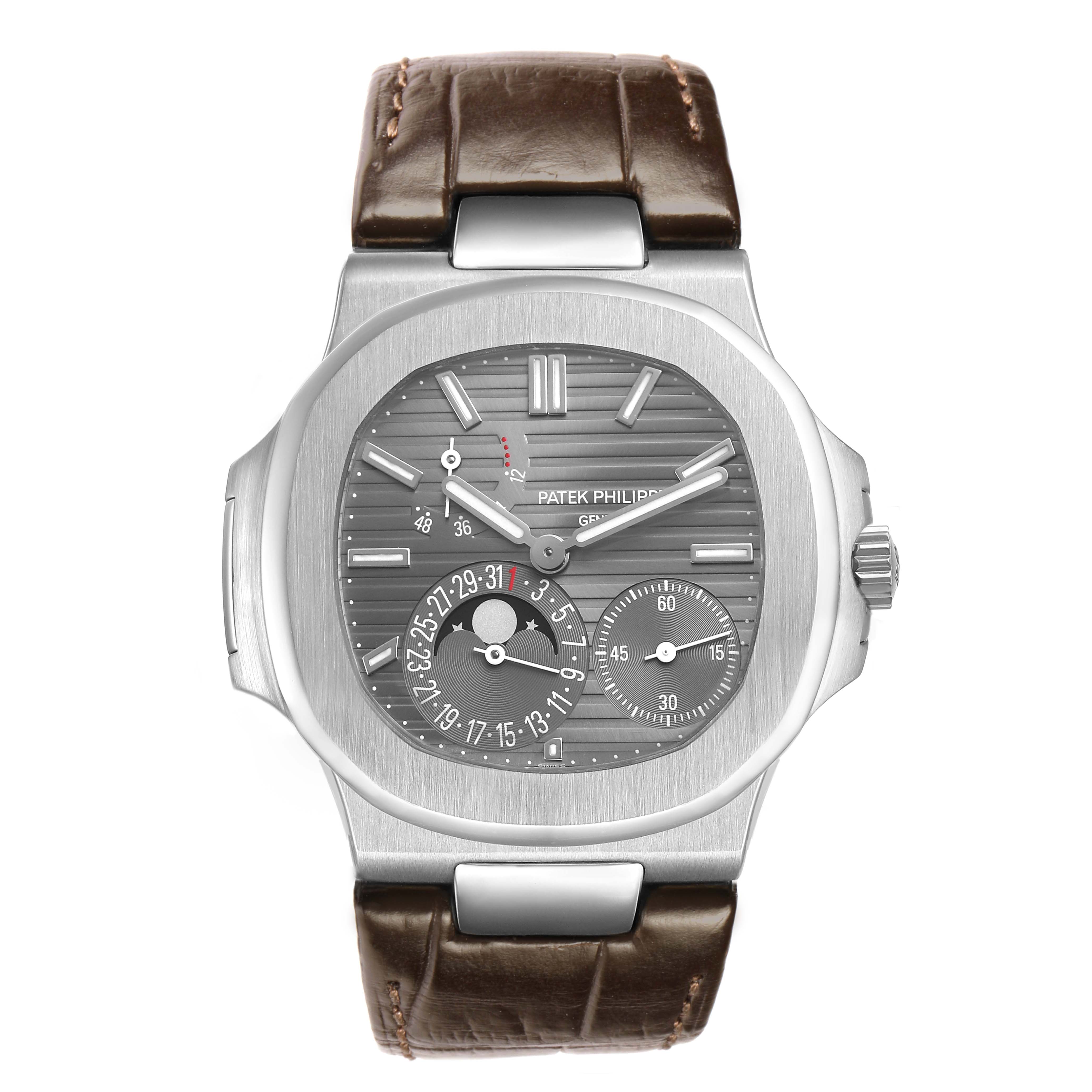 The image shows a frontal view of a Patek Philippe Nautilus 5712G-001 Men's White Gold Grey Dial featuring its face, bezel, and leather strap.