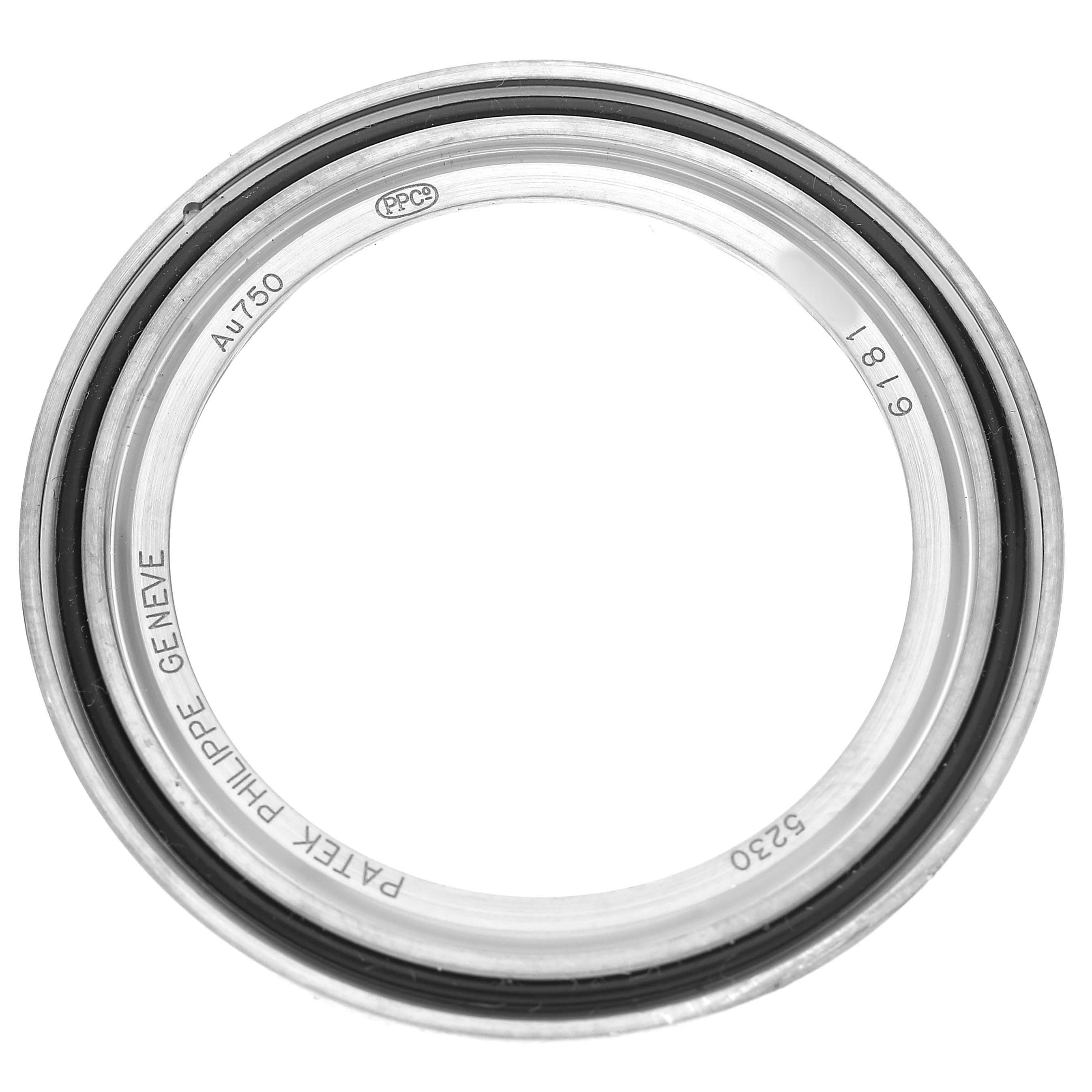 The image shows the bezel of a Patek Philippe Complications 5230G-001 Men's White Gold Grey Dial watch, viewed from a top-down angle.