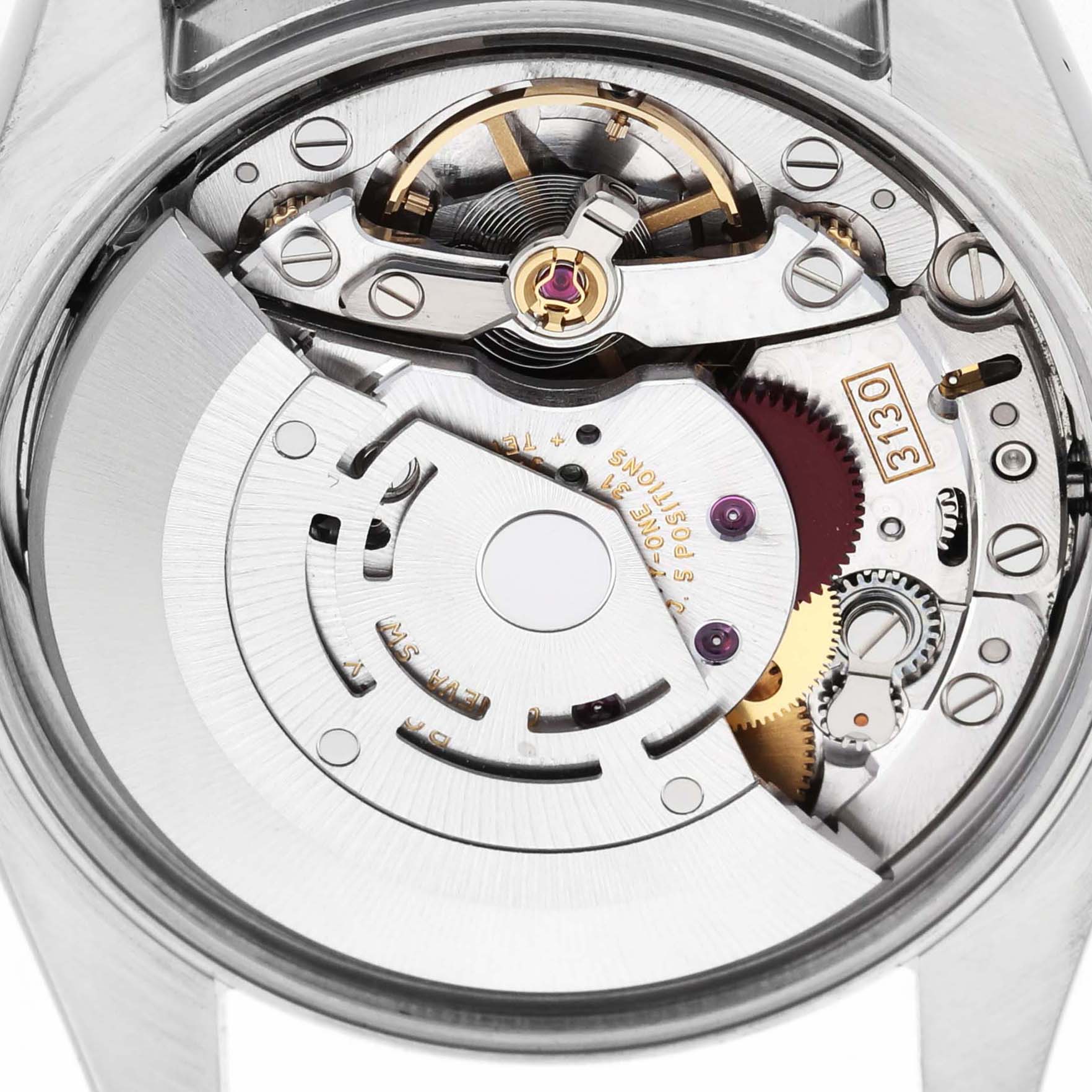 The image shows the movement mechanism of a Rolex Oyster Perpetual 114200 Men's Stainless Steel Blue Dial watch from a top-down angle, highlighting gears and components.