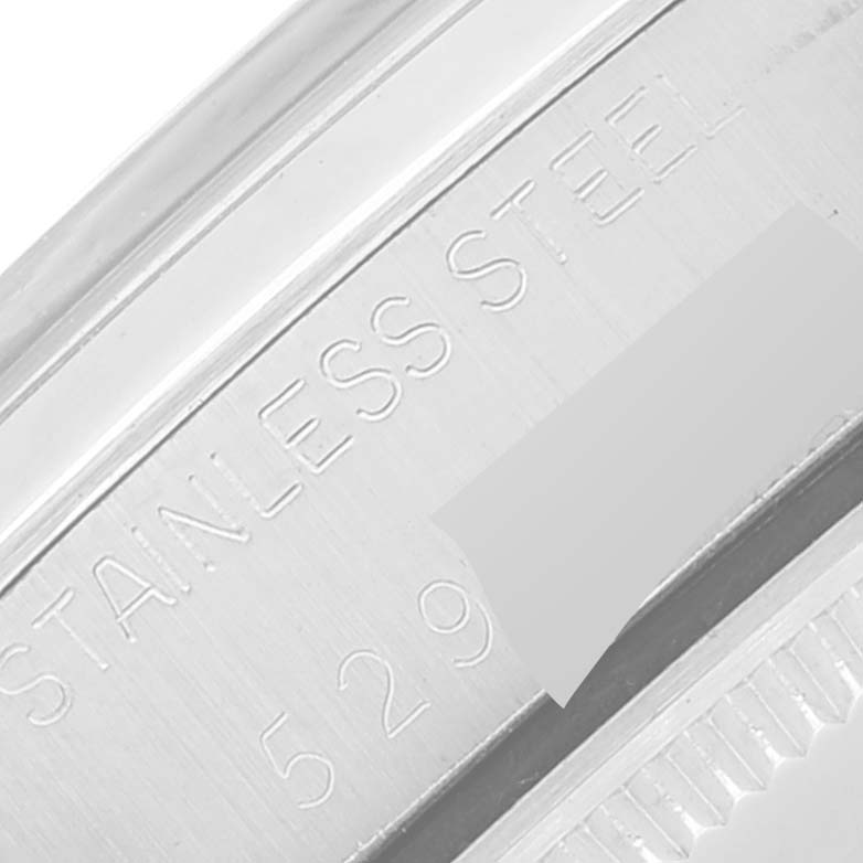 The image shows a close-up of the etched "STAINLESS STEEL" text on the side of the case of a Rolex Air-King 5500 Men's Stainless Steel Silver Dial 5500 Men's Stainless Steel Silver Dial watch.