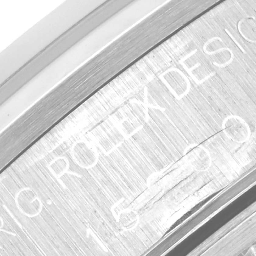 The image shows a close-up of the engraved case side of a Rolex Date 15200 Men's Stainless Steel Blue Dial 15200 Men's Stainless Steel Blue Dial model watch, featuring the brand and model details.