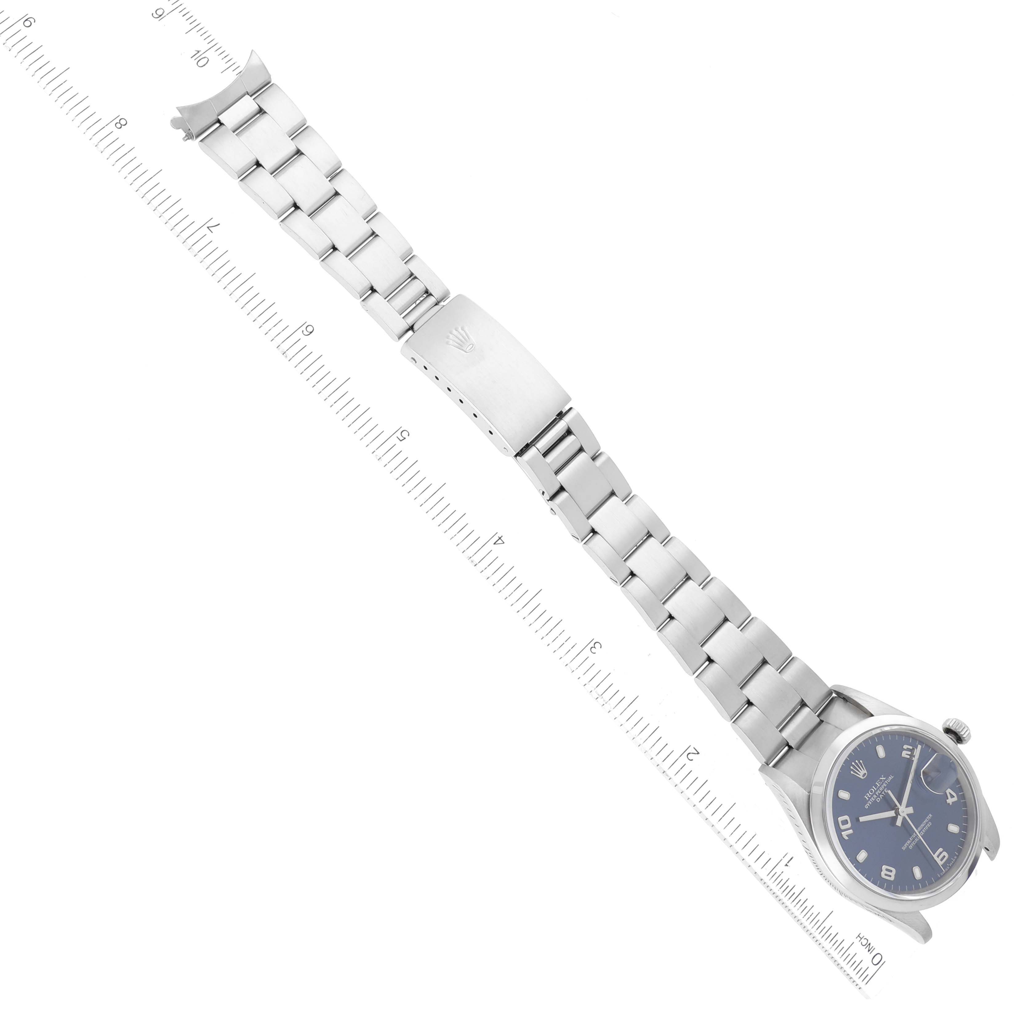 The image shows the Rolex Date 15200 Men's Stainless Steel Blue Dial 15200 Men's Stainless Steel Blue Dial model watch lying flat with the bracelet and clasp visible alongside a centimeter ruler for scale.