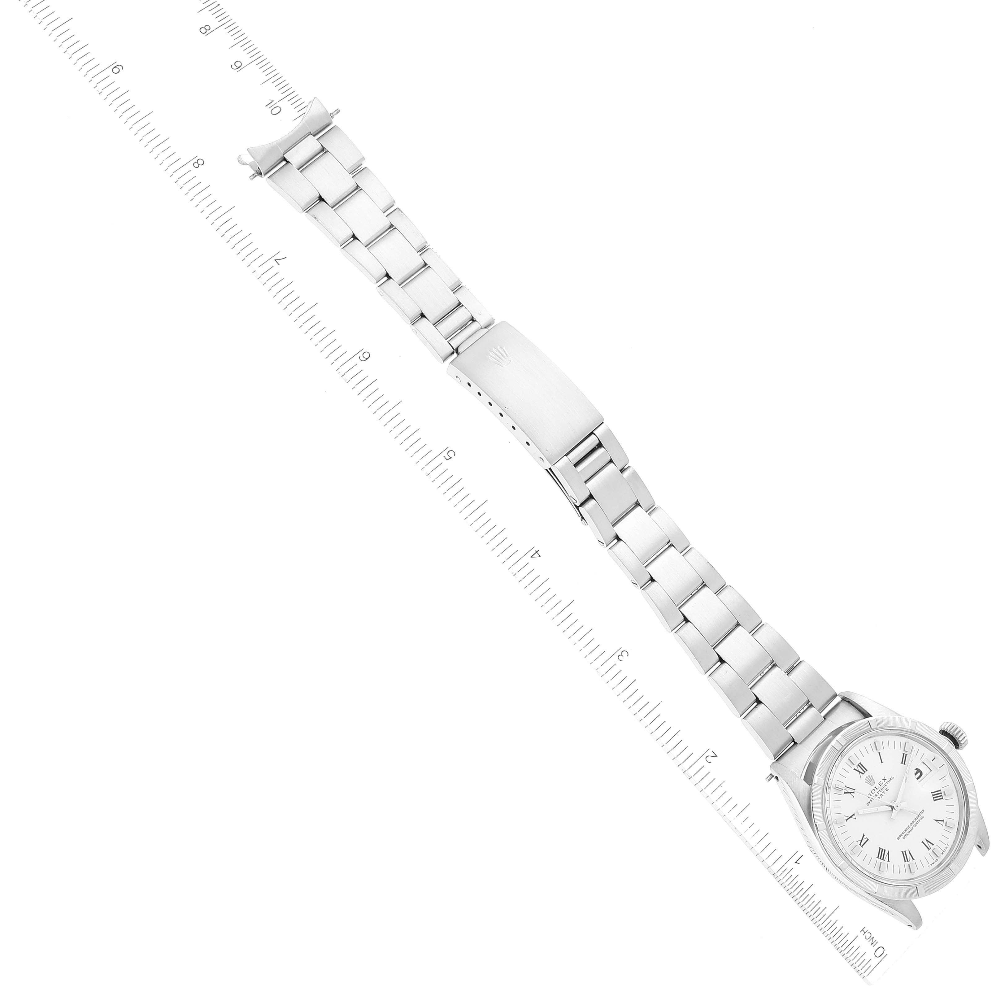 The image shows a top-down view of a Rolex Vintage Collection 1501 Men's Stainless Steel White Dial 1501 Men's Stainless Steel White Dial watch, including its face, band, and clasp, aligned next to a ruler.