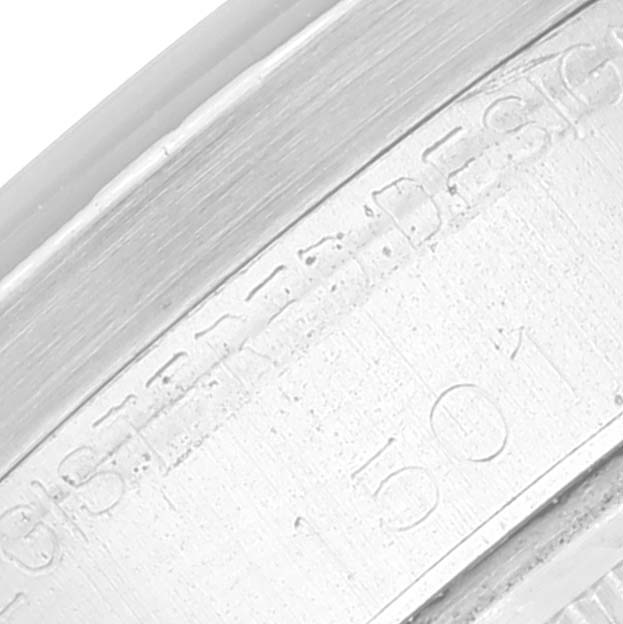 The image shows a close-up of the etched side of the bezel's inner ring of a Rolex Vintage Collection 1501 Men's Stainless Steel White Dial 1501 Men's Stainless Steel White Dial watch.