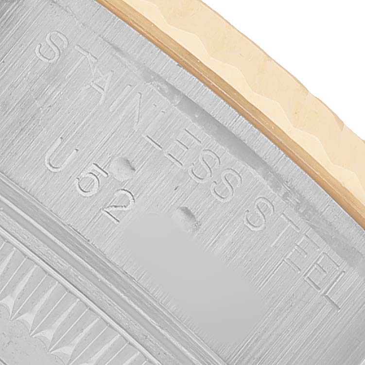 The image shows a close-up of the side of the Rolex Datejust 69173 Women's Steel and Gold (two tone) Champagne Dial watch, focusing on the stainless steel and markings.