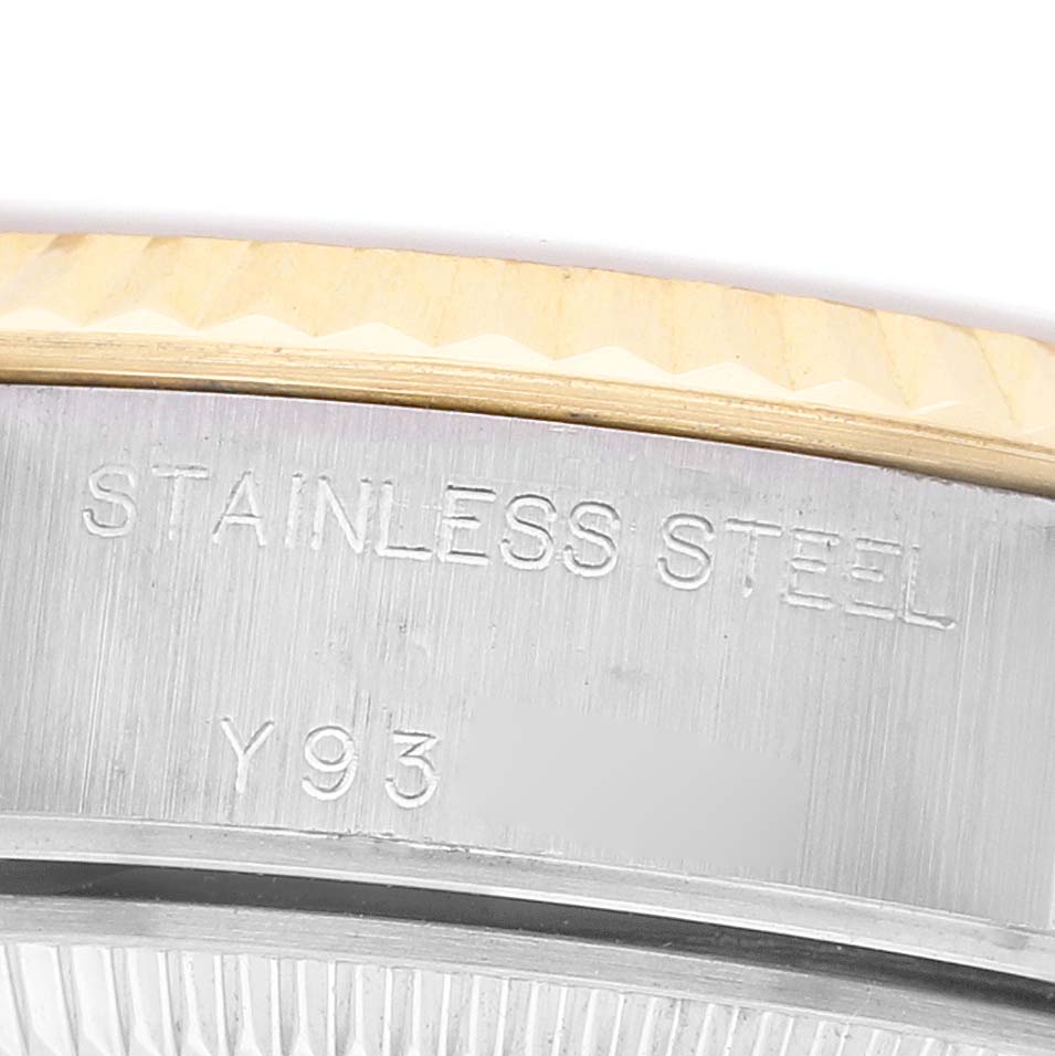 The image shows a close-up of the side of a Rolex Datejust 79173 Women's Steel and Gold (two tone) Silver Dial's stainless steel casing with engravings.