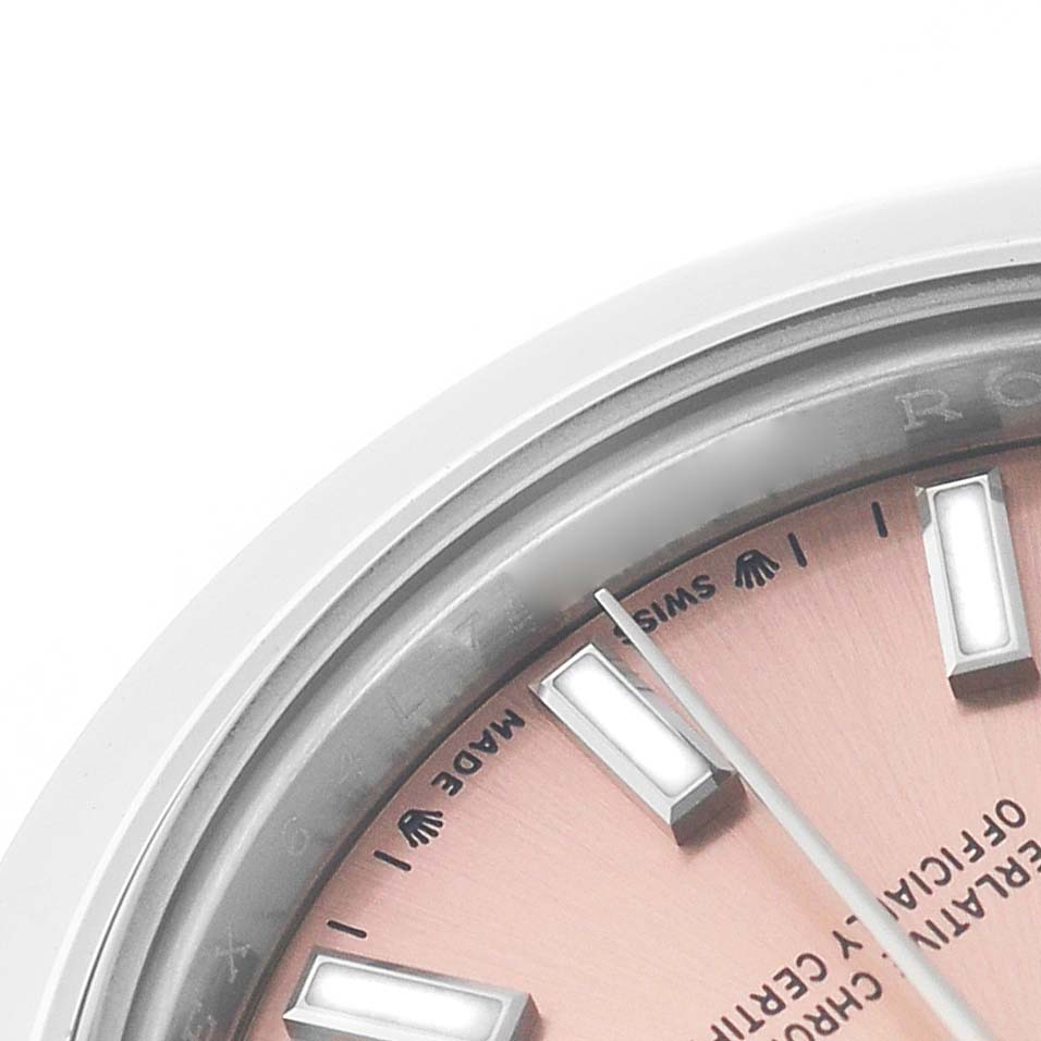 The image shows a close-up of the dial edge and hour markers on a Rolex Datejust 279160 Women's Stainless Steel Pink Dial watch, with a focus on the logo and text.