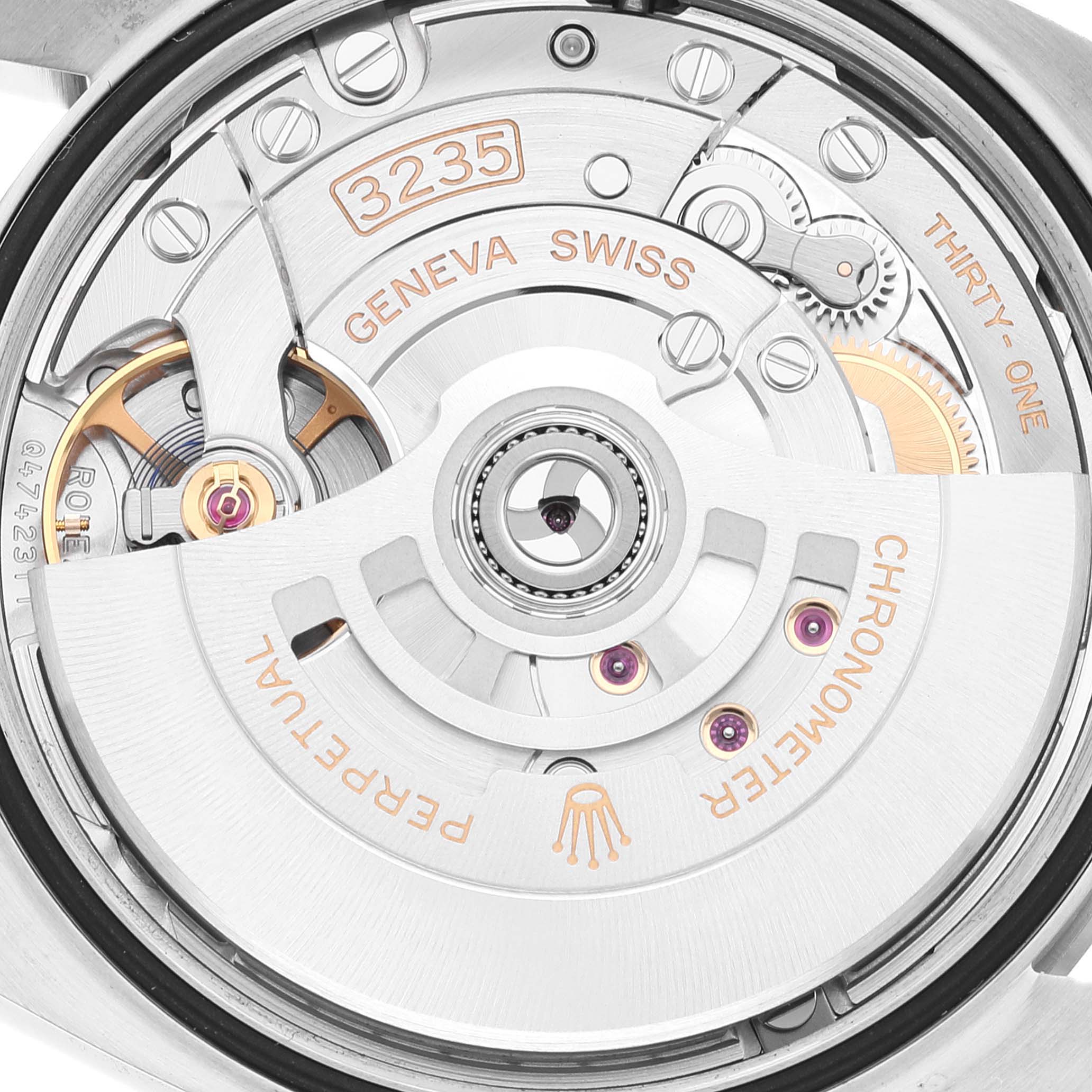 The image shows the close-up view of the movement mechanism of a Rolex Datejust 126200 Men's Stainless Steel Green Dial 126200 Men's Stainless Steel Green Dial watch, highlighting the 3235 caliber and Geneva Swiss engravings.