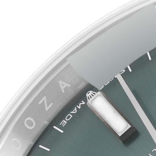 The image shows a close-up of the dial and hour markers of a Rolex Datejust 126200 Men's Stainless Steel Green Dial 126200 Men's Stainless Steel Green Dial watch.