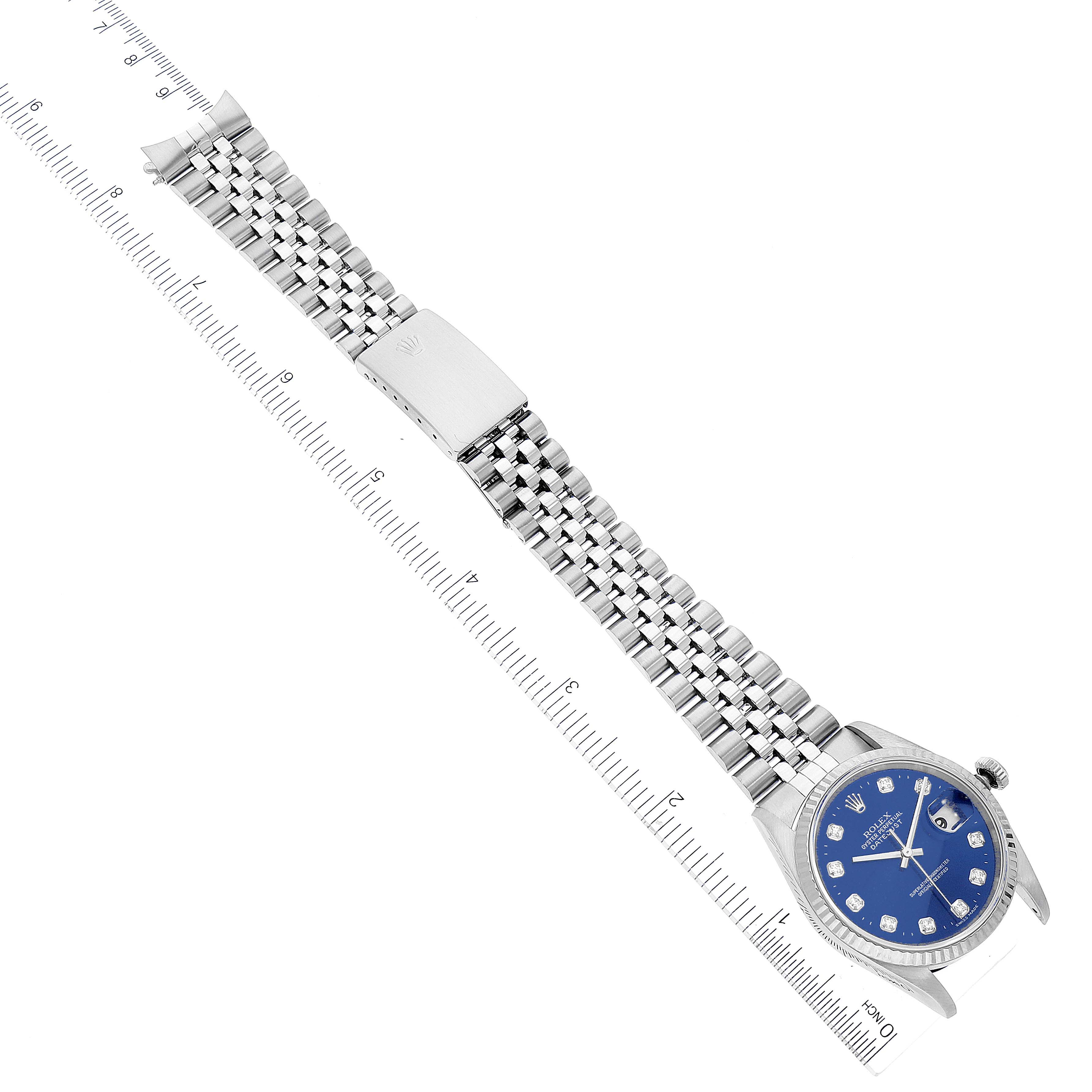 The image shows a Rolex Datejust 16234 Men's Stainless Steel Blue Dial 16234 Men's Stainless Steel Blue Dial watch lying flat with its face and full metal bracelet visible alongside a measurement ruler.