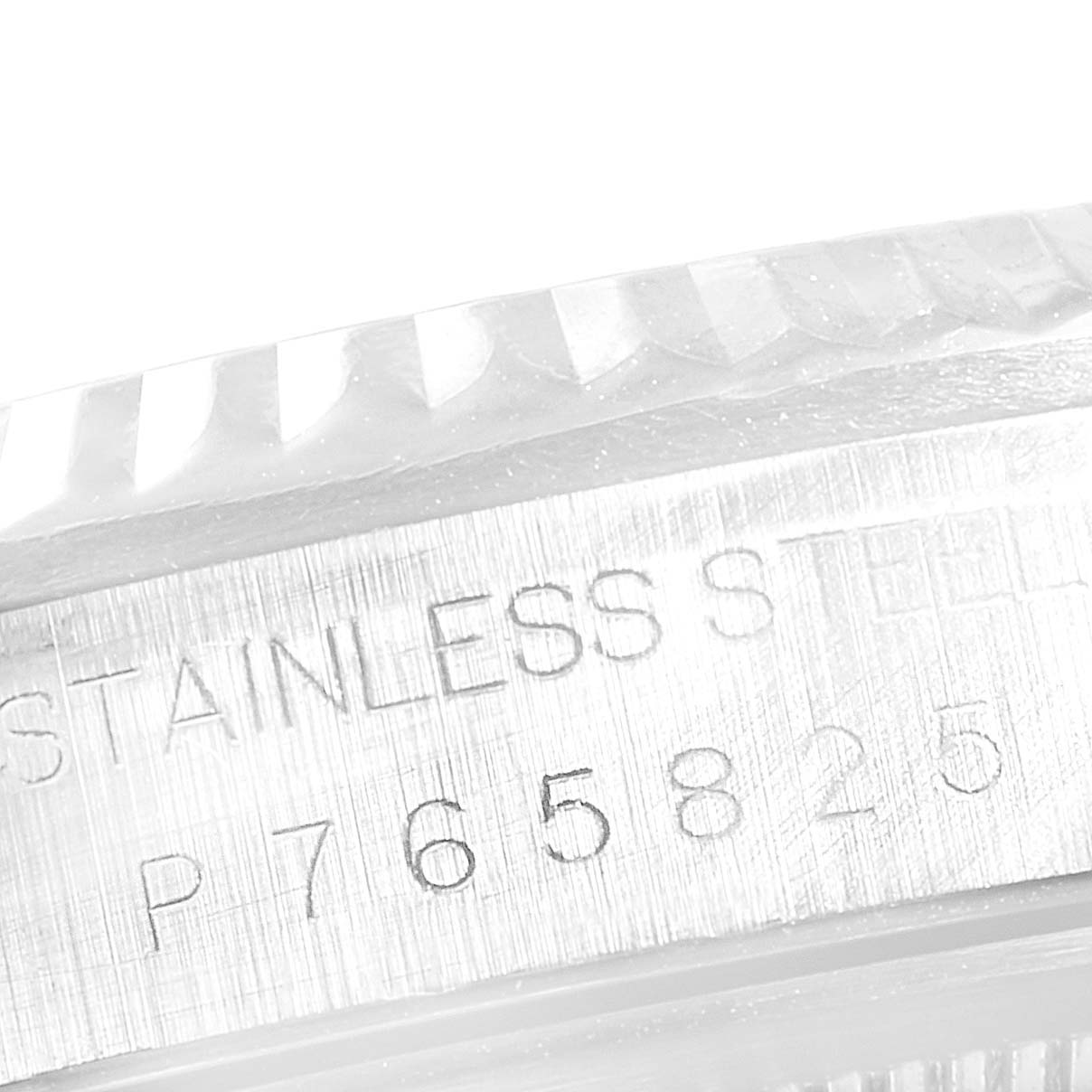 This close-up shows the stainless steel bezel and serial number engraving of a Rolex Datejust 16234 Men's Stainless Steel White Dial 16234 Men's Stainless Steel White Dial watch.