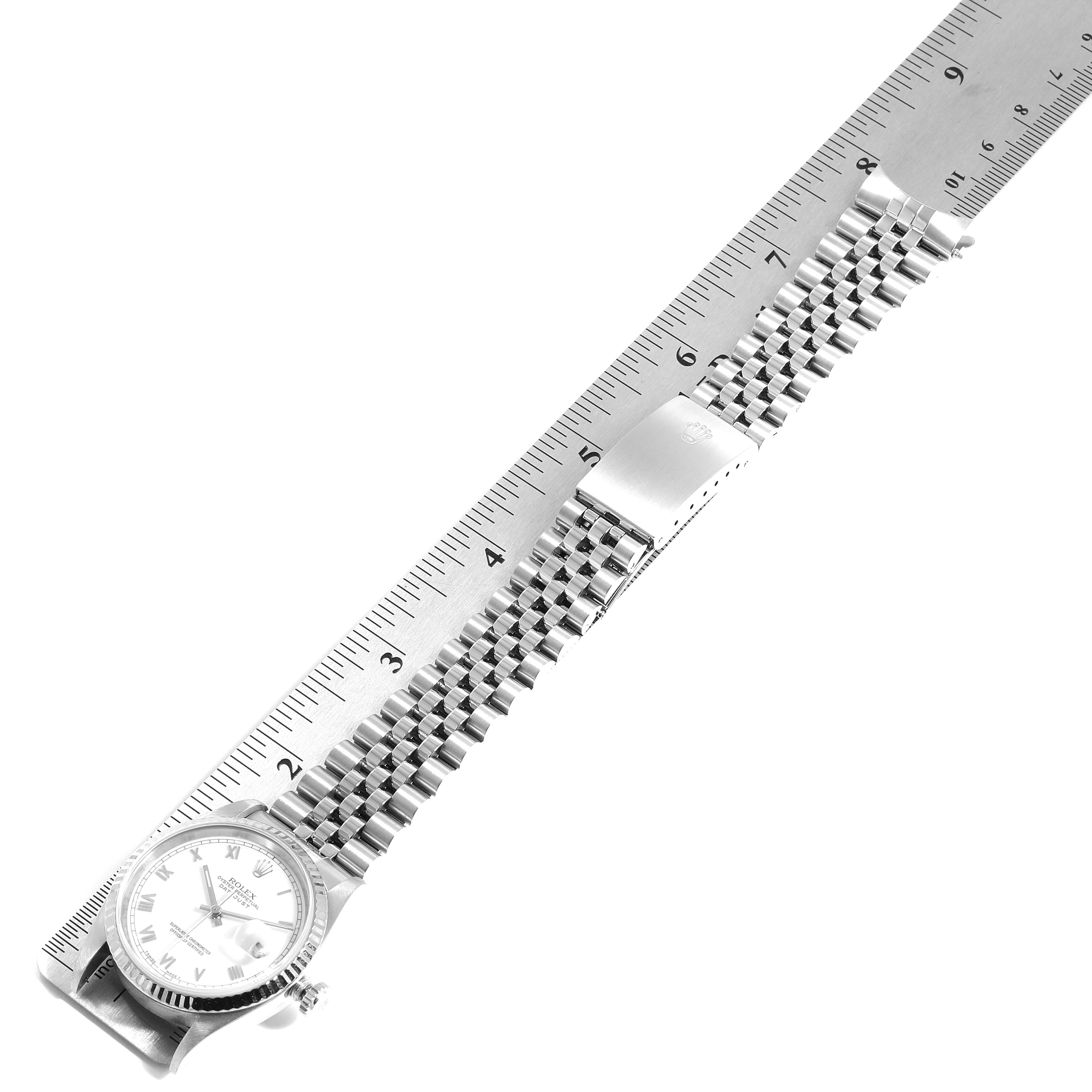The image shows a Rolex Datejust 16234 Men's Stainless Steel White Dial 16234 Men's Stainless Steel White Dial watch laid flat next to a ruler, highlighting the bracelet and clasp.