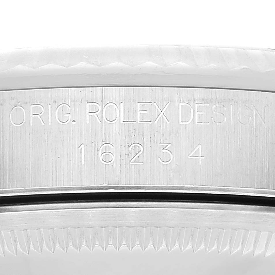 This image shows the case side of a Rolex Datejust 16234 Men's Stainless Steel Silver Dial 16234 Men's Stainless Steel Silver Dial watch, displaying the model number and "ORIG. ROLEX DESIGN" engraving.