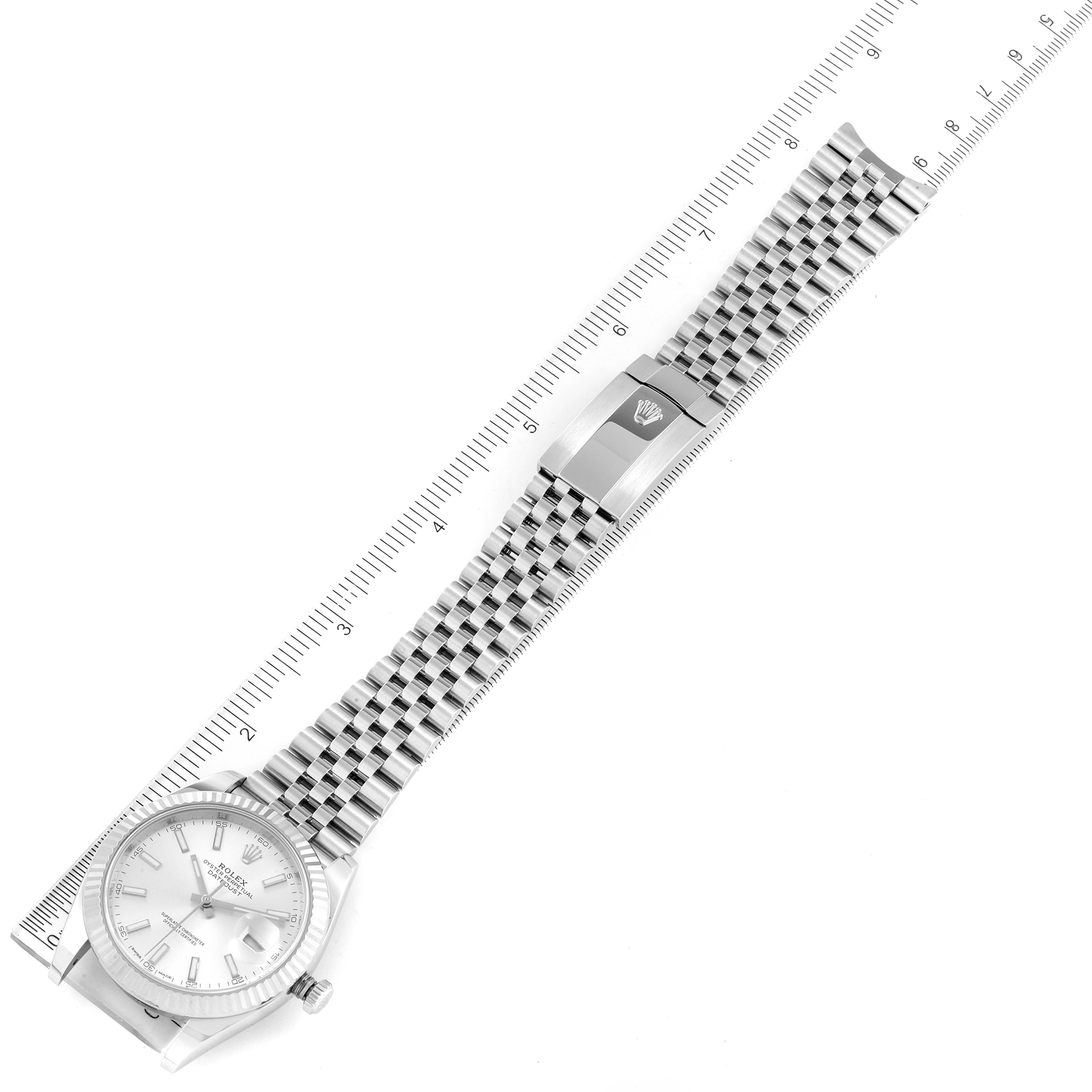 The image shows a top-down view of a Rolex Datejust 41 126334 Men's Stainless Steel Silver Dial 126334 Men's Stainless Steel Silver Dial watch, displaying the case, dial, and bracelet with a ruler for scale.
