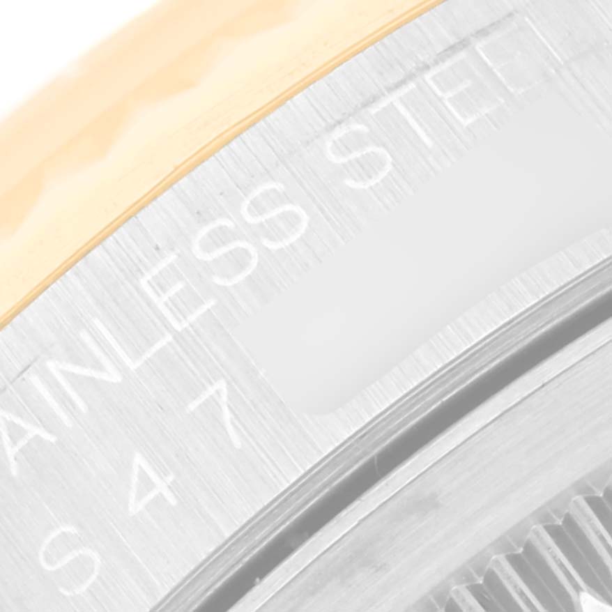 The image shows a close-up of the Rolex Datejust 16233 Men's Steel and Gold (two tone) Champagne Dial 16233 Men's Steel and Gold (two tone) Champagne Dial watch case back, highlighting the stainless steel text engraving.