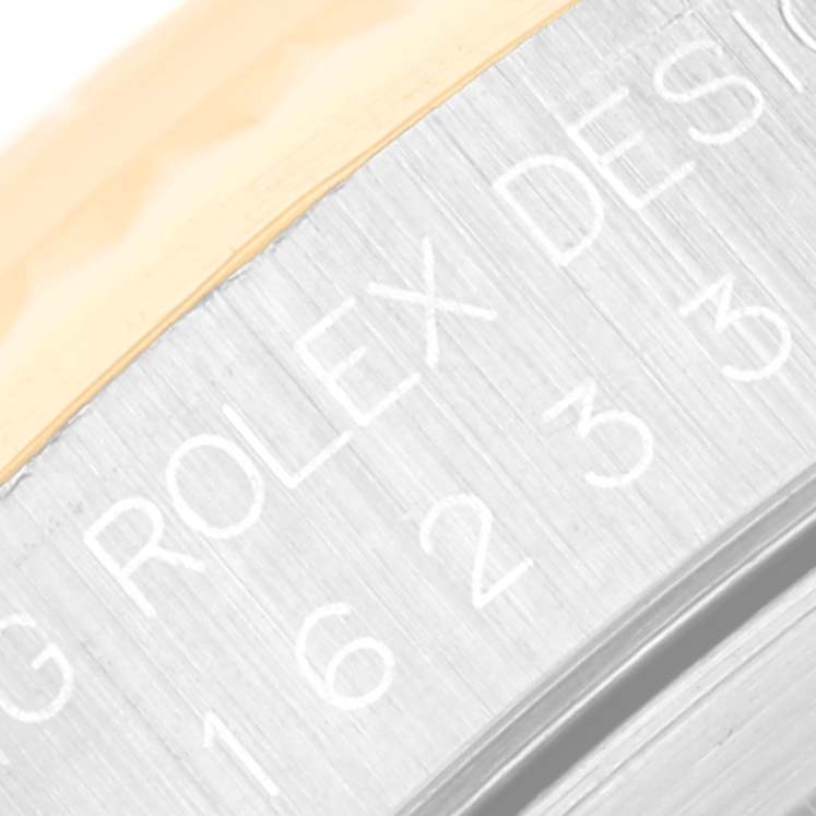 This close-up image showcases the engraving on the case of a Rolex Datejust 16233 Men's Steel and Gold (two tone) Champagne Dial 16233 Men's Steel and Gold (two tone) Champagne Dial watch.