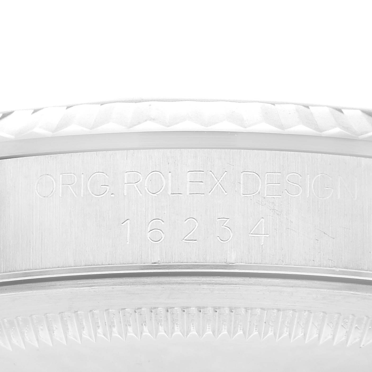 This image shows a close-up of the side of the case of a Rolex Datejust 16234 Men's Stainless Steel Silver Dial 16234 Men's Stainless Steel Silver Dial watch with the model number and "Orig. Rolex Design" engraved.