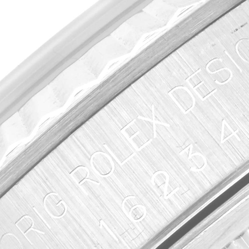 This close-up image shows an engraving on the side of the Rolex Datejust 16234 Men's Stainless Steel Silver Dial 16234 Men's Stainless Steel Silver Dial model case.