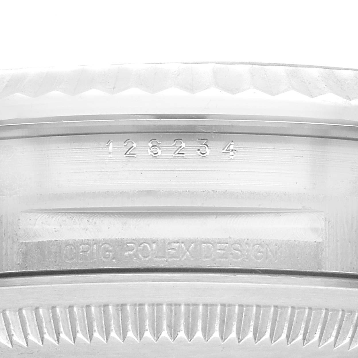 Close-up of the case side of the Rolex Datejust 126234 Men's Stainless Steel Blue Dial 126234 Men's Stainless Steel Blue Dial watch showing the engraved model number and the "ROLEXDESIGN" engraving.